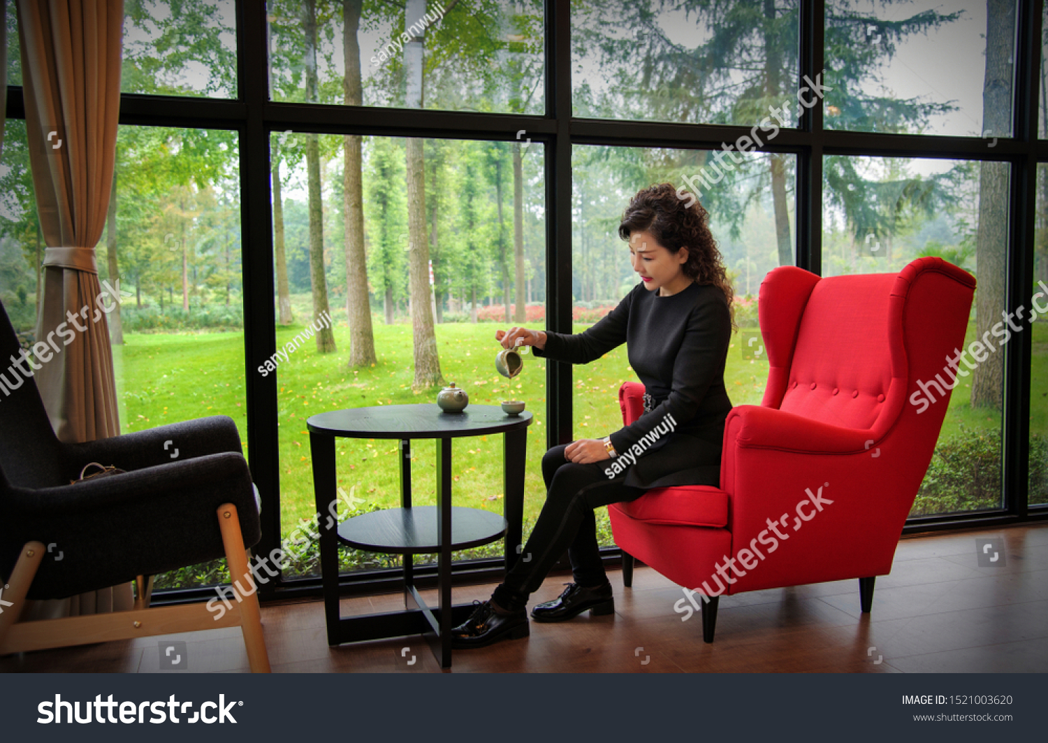 The woman that sits on armchair drinks tea, recreational and recreational idea #1521003620