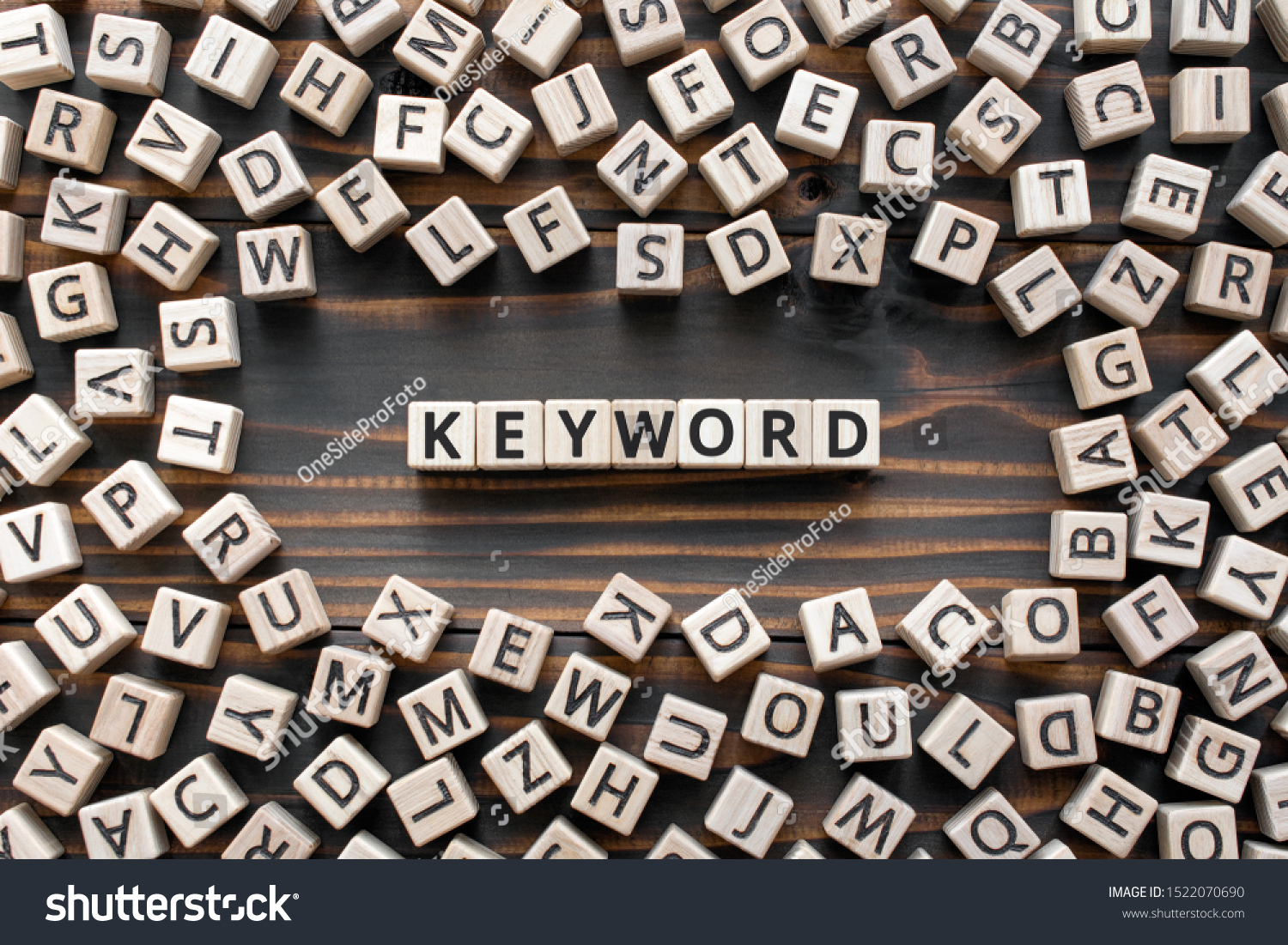 Keyword - word from wooden blocks with letters, search information that contains that word keyword concept, random letters around, top view on wooden background #1522070690
