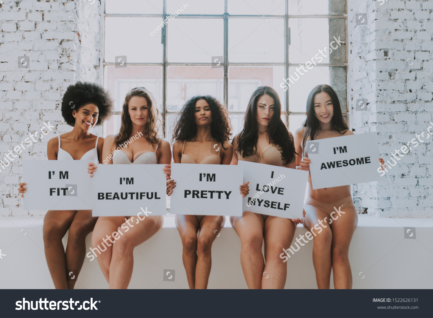 Group of women with different body and ethnicity posing together to show the woman power and strength. Curvy and skinny kind of female body concept #1522626131