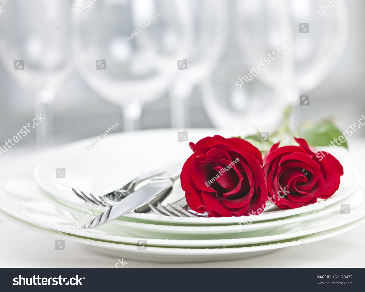 Romantic restaurant table setting for two with roses plates and cutlery #152279477