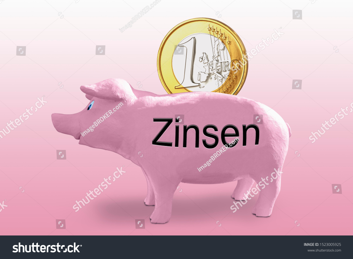 Large one euro coin in a pink piggy bank labelled Zinsen, German for interest rates, symbolic image #1523005925