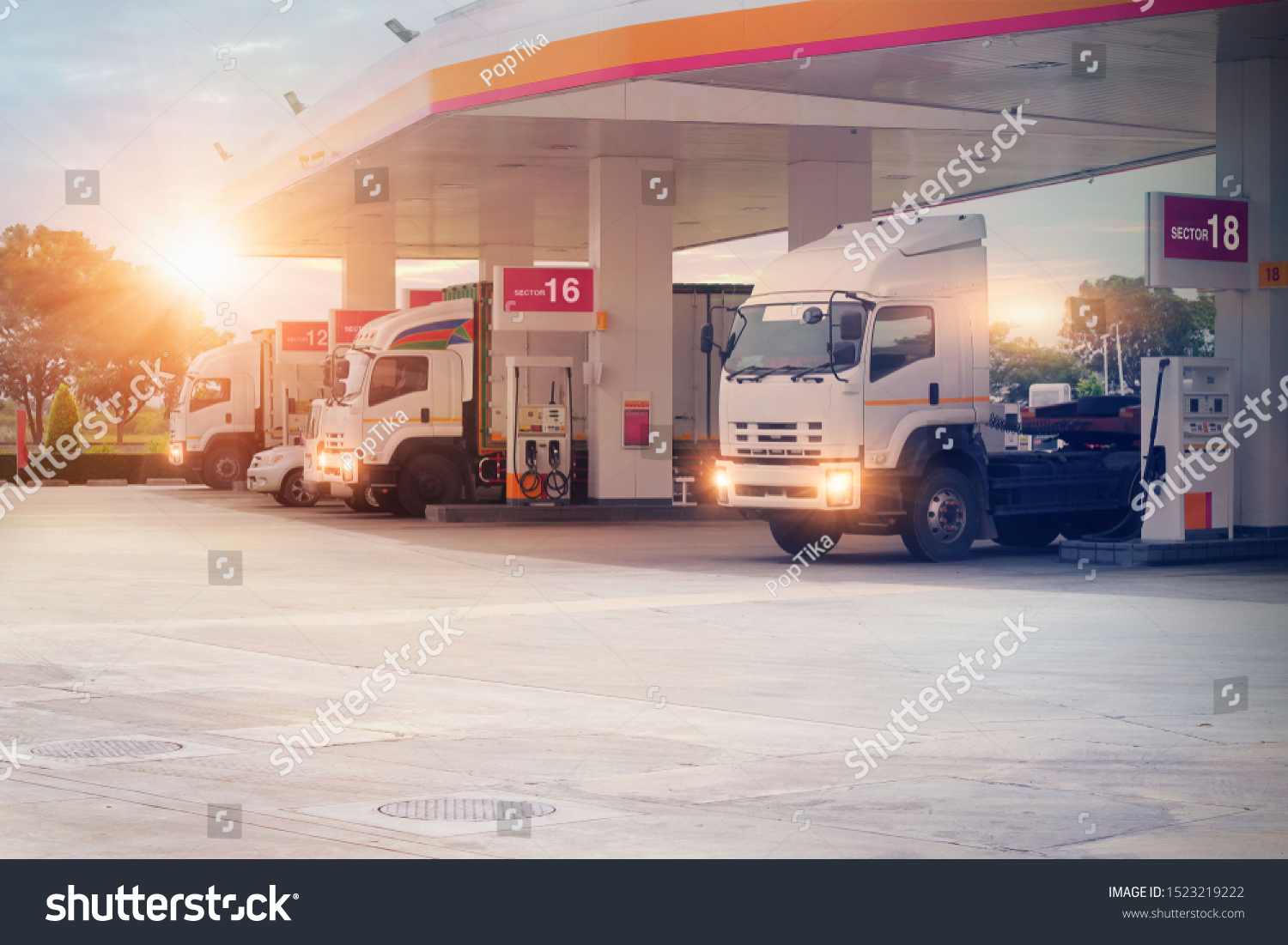 Trucks refueling in petrol station, Transportation vehicle, Business logistics, delivery transport, cargo logistic concept. Freight shipping, at sunset background. #1523219222