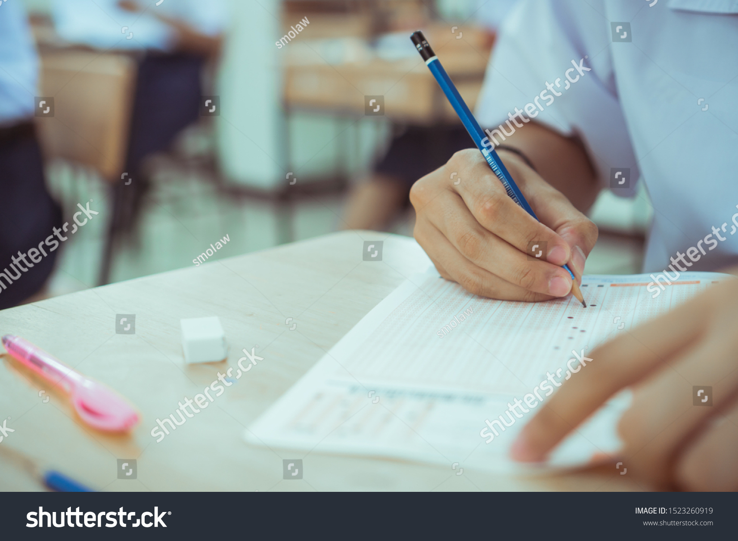 test exam for education in school concept : University student holding pencil notes paper on answer sheet at lecture chair for taking exams in examination classroom. Assessment learning in class ideas #1523260919