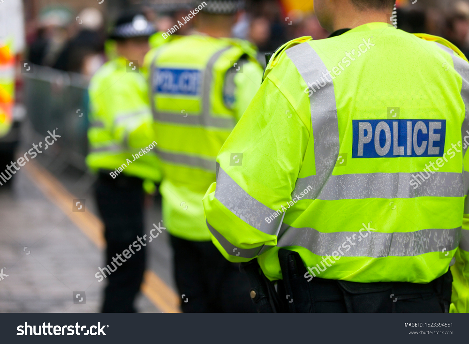 Police in hi-visibility jackets policing crowd control at a UK event #1523394551