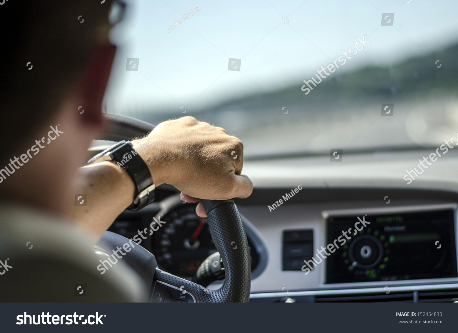 Generic photo of man driving a car through slight turn. #152454830