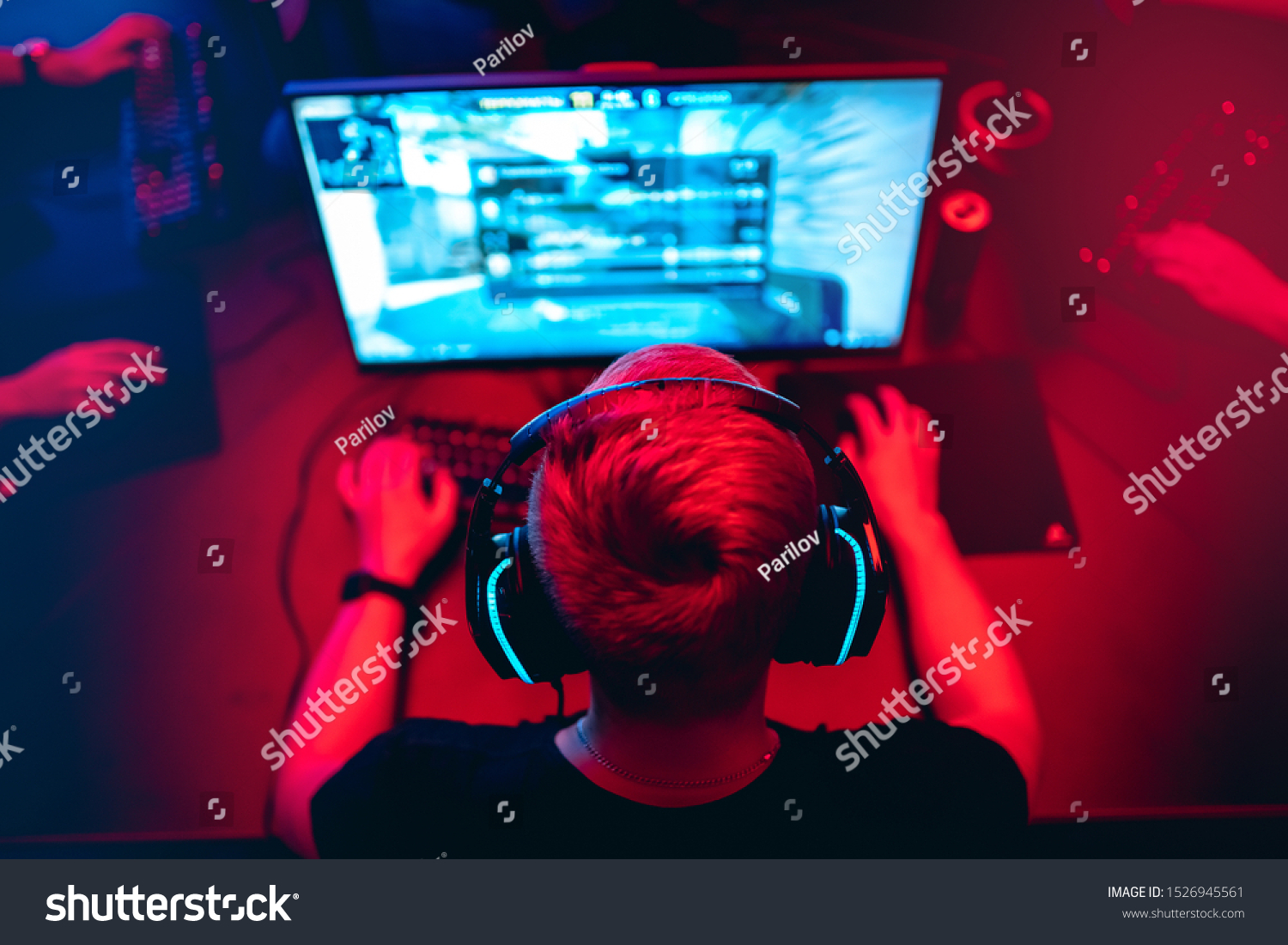 Professional cyber gamer studio room with personal computer armchair, keyboard for stream in neon color blur background. Soft focus. #1526945561