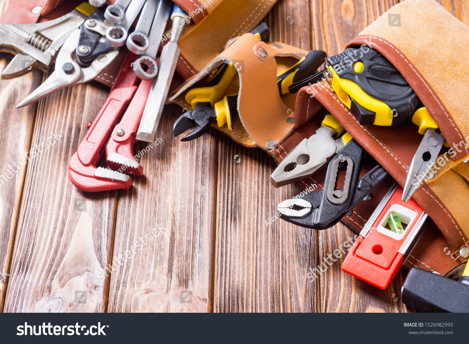 Tool belt with hand tools . Work background on wooden board #1526982995