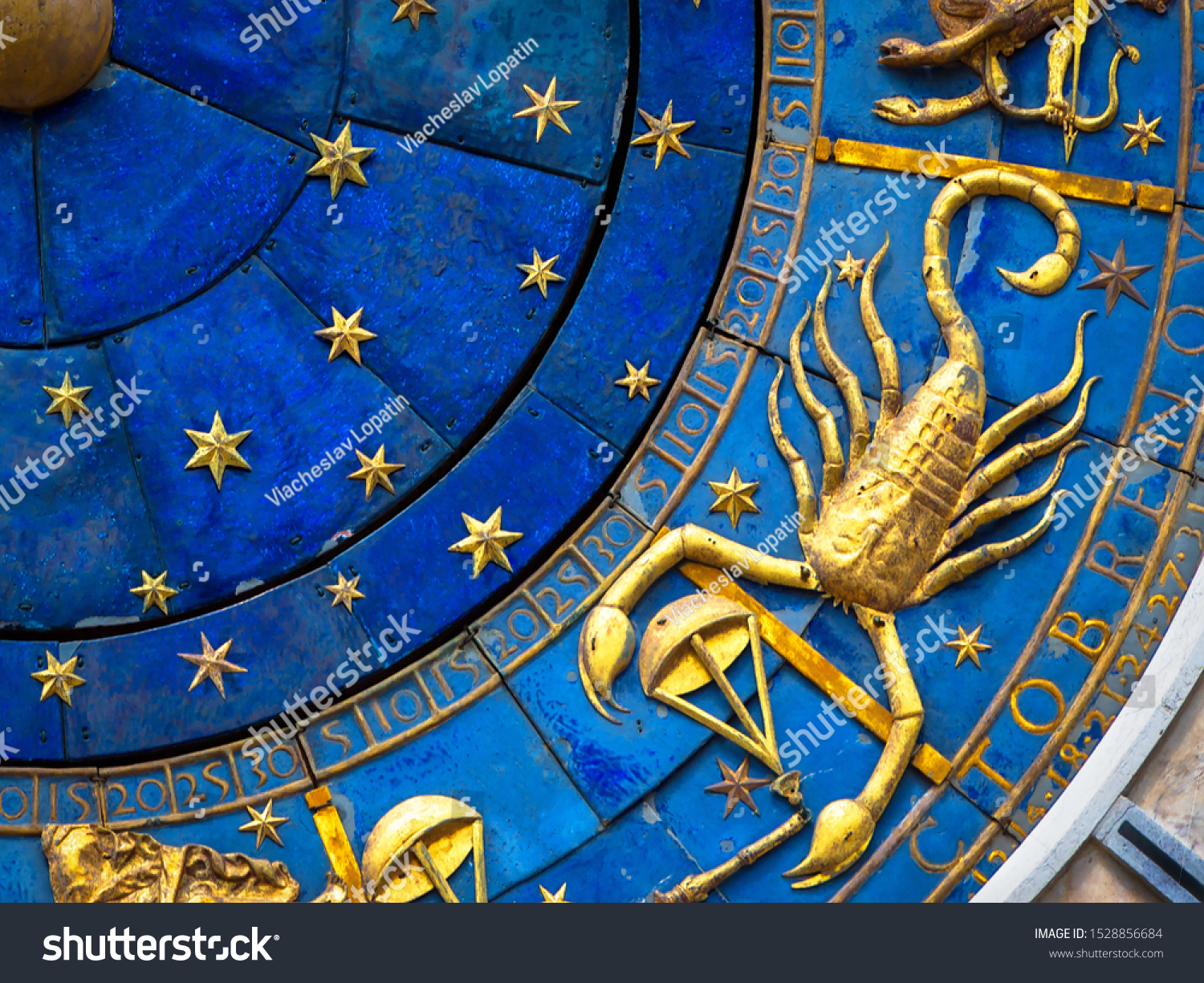 Scorpio astrological sign on ancient clock, Venice, Italy. Detail of Zodiac wheel with scorpion, golden horoscope icon of scorpio closeup. Scorpio symbol on star circle. November and horoscope theme. #1528856684
