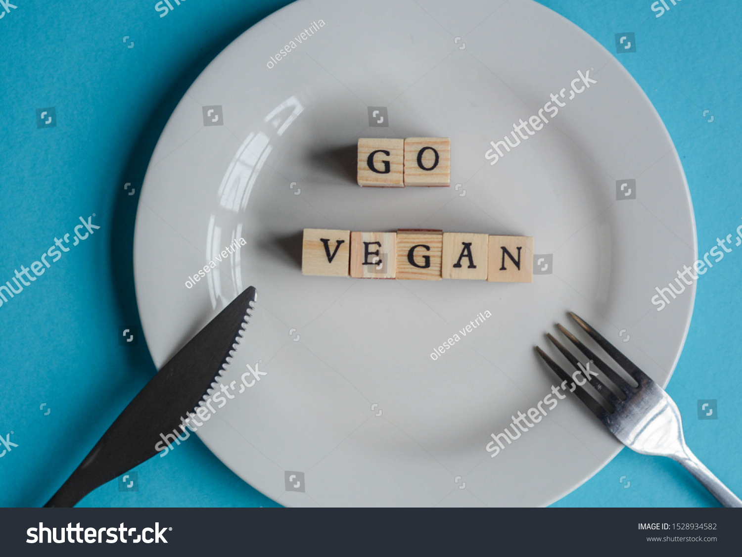 'Go Vegan' made from wooden letters on a white plate to represent concept about veganism movement  #1528934582