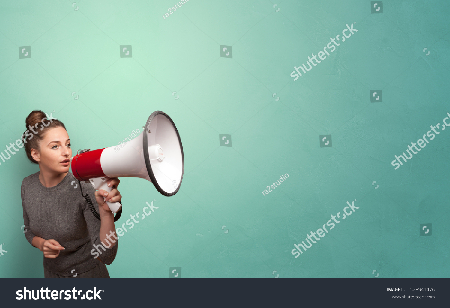 Person speaking in loudspeaker concept #1528941476