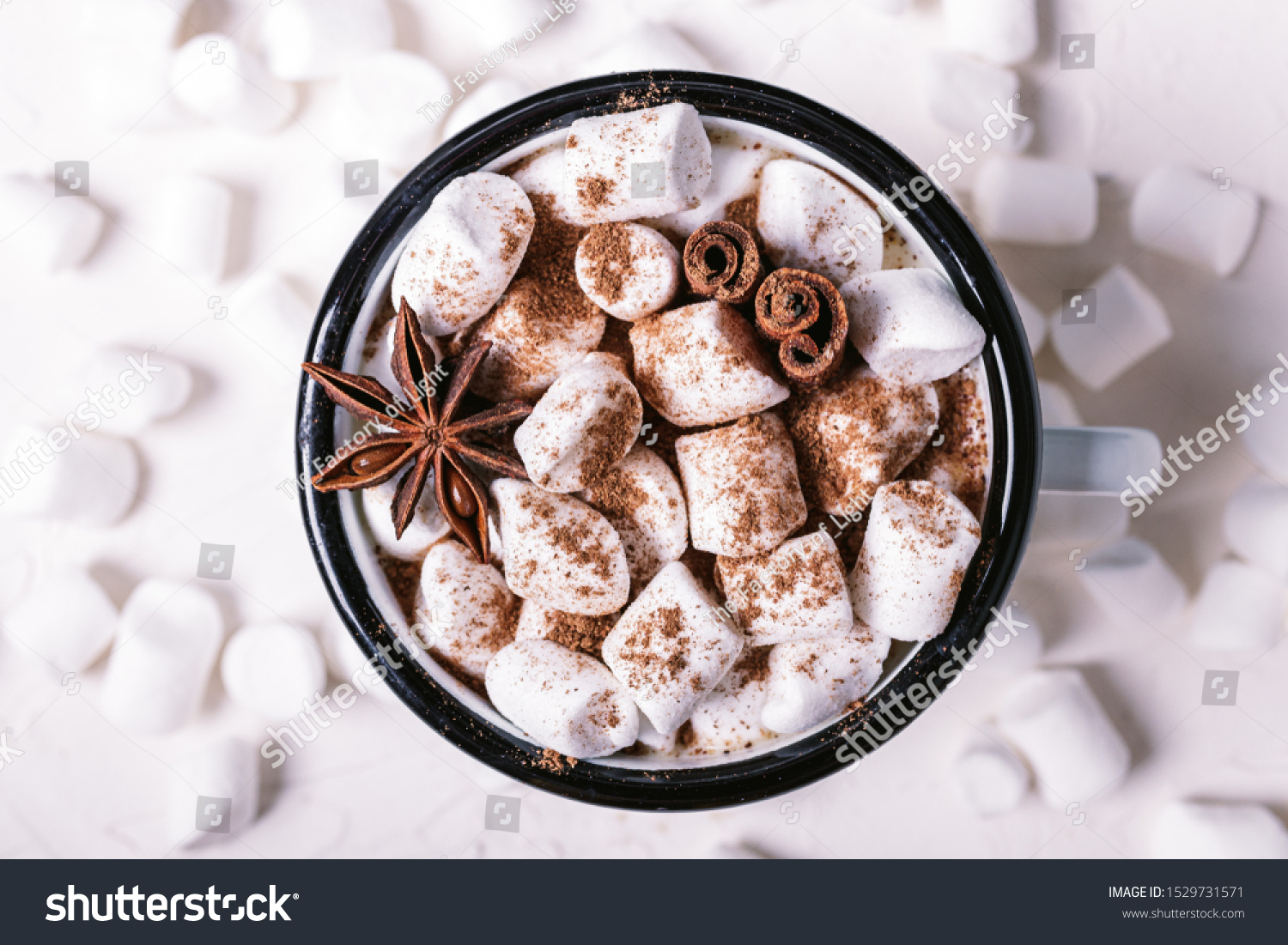 Metal mug of hot chocolate with marshmallows on white background. Сinnamon and star anise. #1529731571