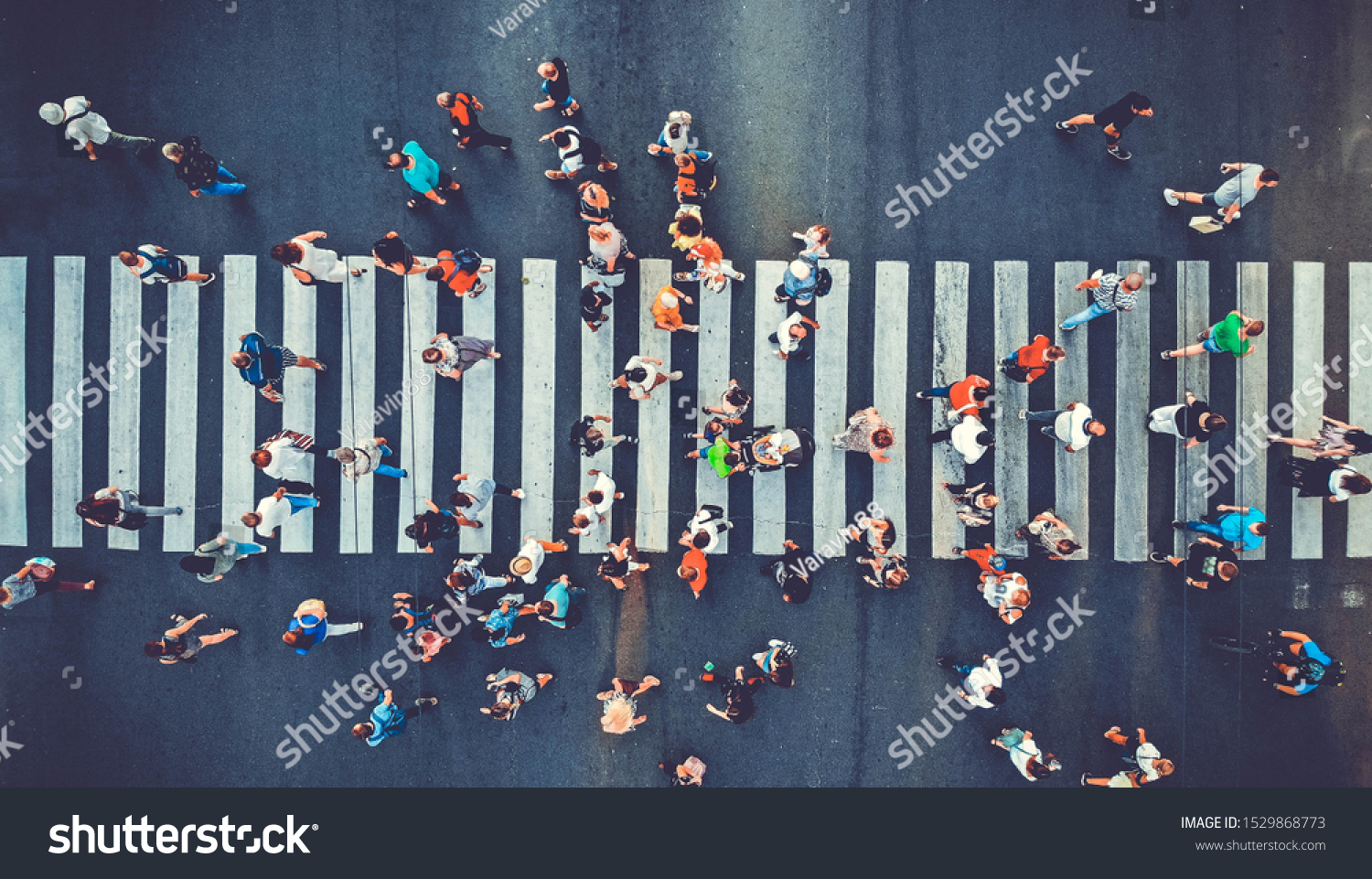 Aerial. People crowd motion through the pedestrian crosswalk. Top view from drone. Toned image. #1529868773