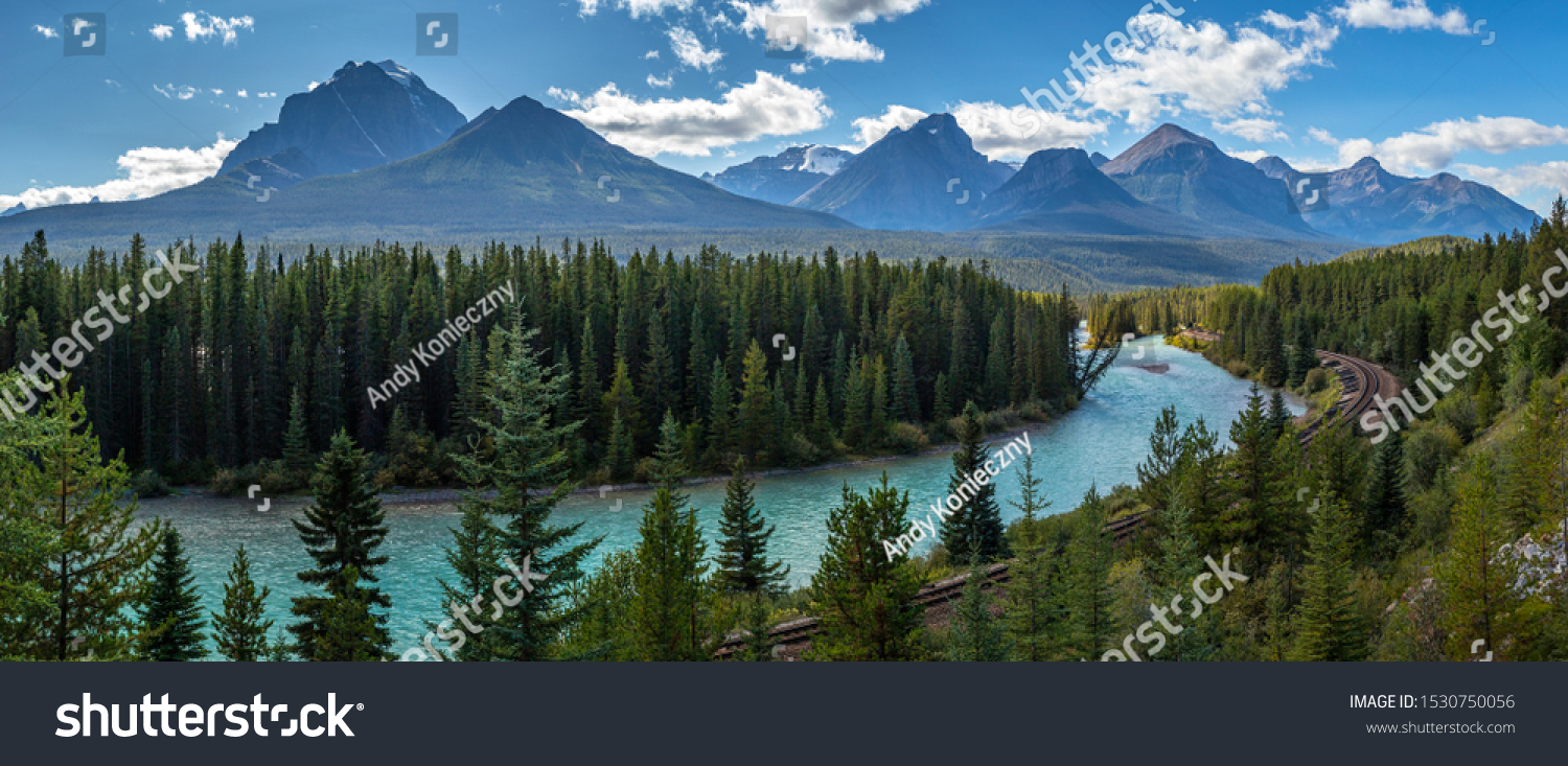Iconic view of Morants Curve where the Canadian Pacific Railway runs along the stunning Bow River with the beautiful Canadian Rockies in the background, Banff National Park, Alberta, Canada #1530750056