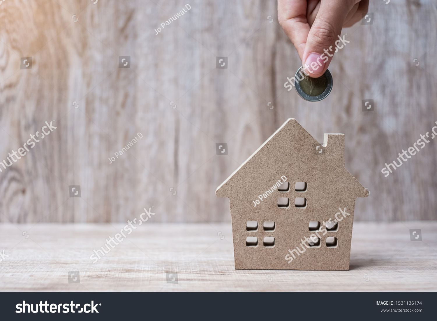 Man hand putting coin over house model on wooden background. Banking, real estate, investment, success, financial and savings concepts #1531136174