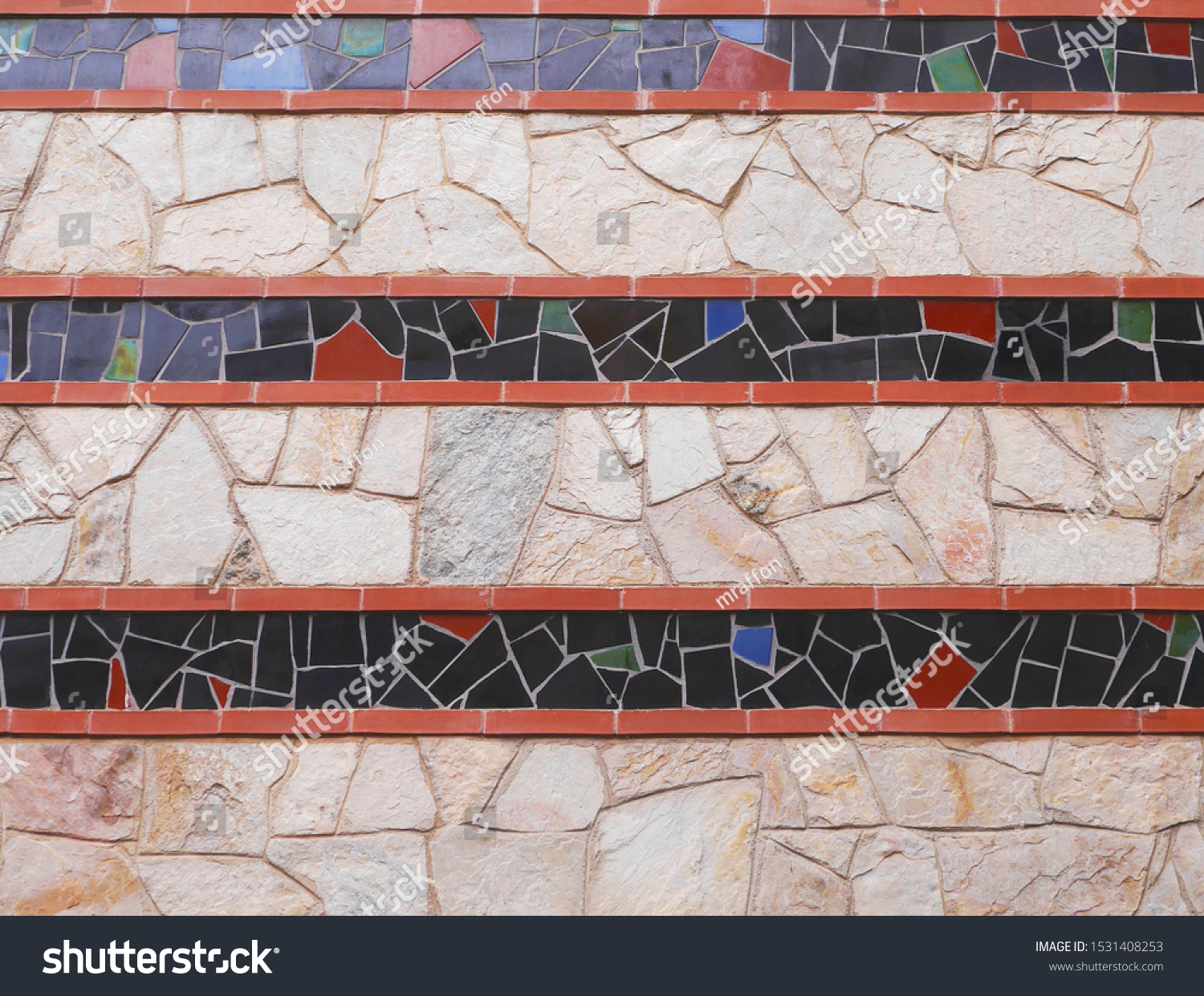 Mosaic border with 
stone masonry. Stone border with mosaic interspersed. #1531408253