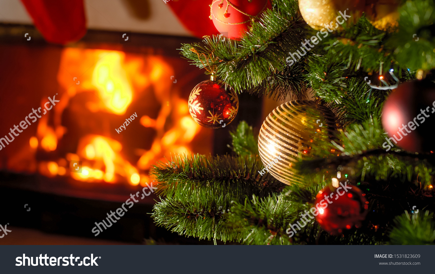 Background of burning fireplace and decorated Christmas tree with baubles and garlands #1531823609