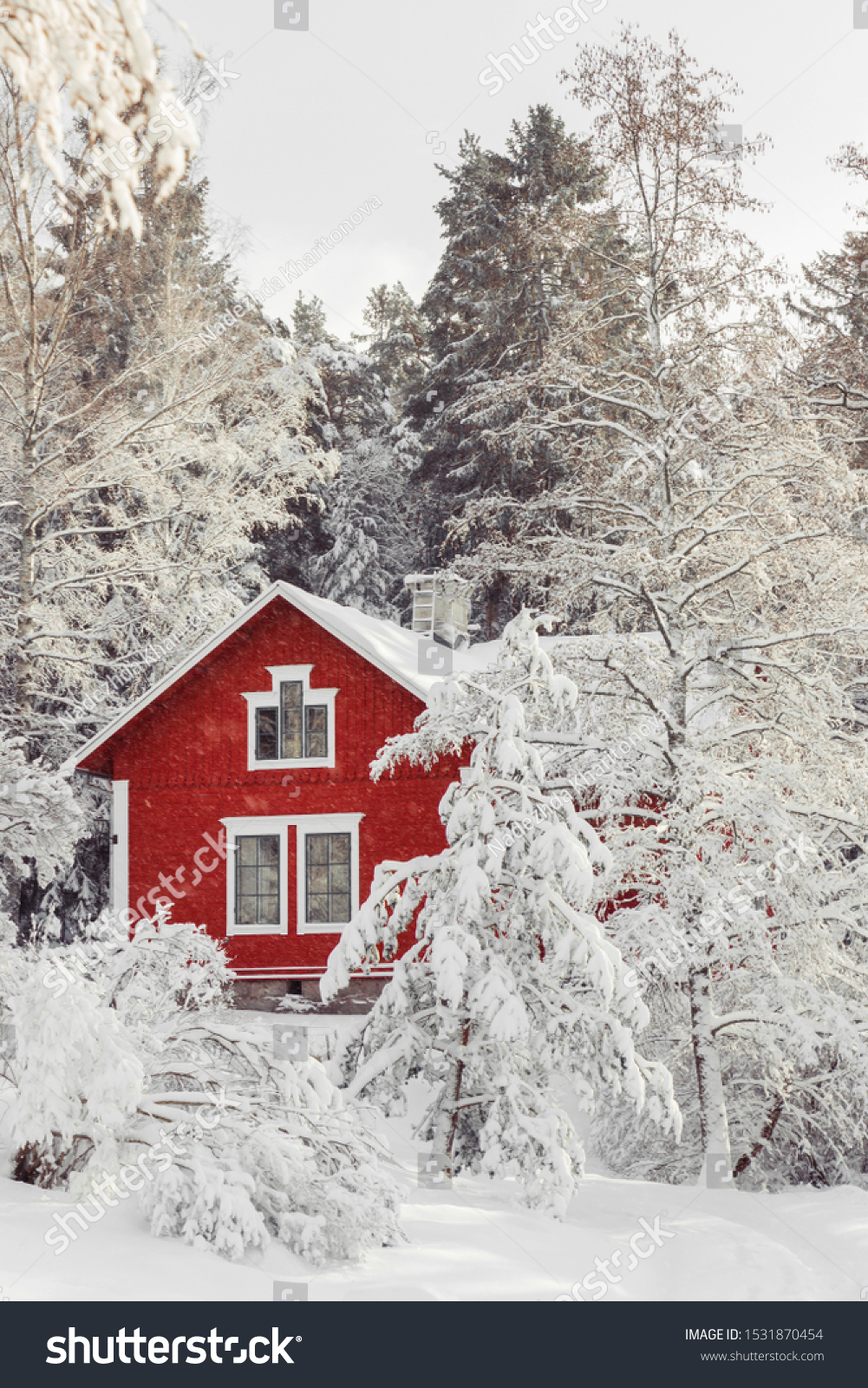 Beautiful red wooden house in snow fairy forest Sweden. House painted in traditional Swedish color. Winter scenery with red cottage surrounded by trees covered with snow and frost. Space for your text #1531870454