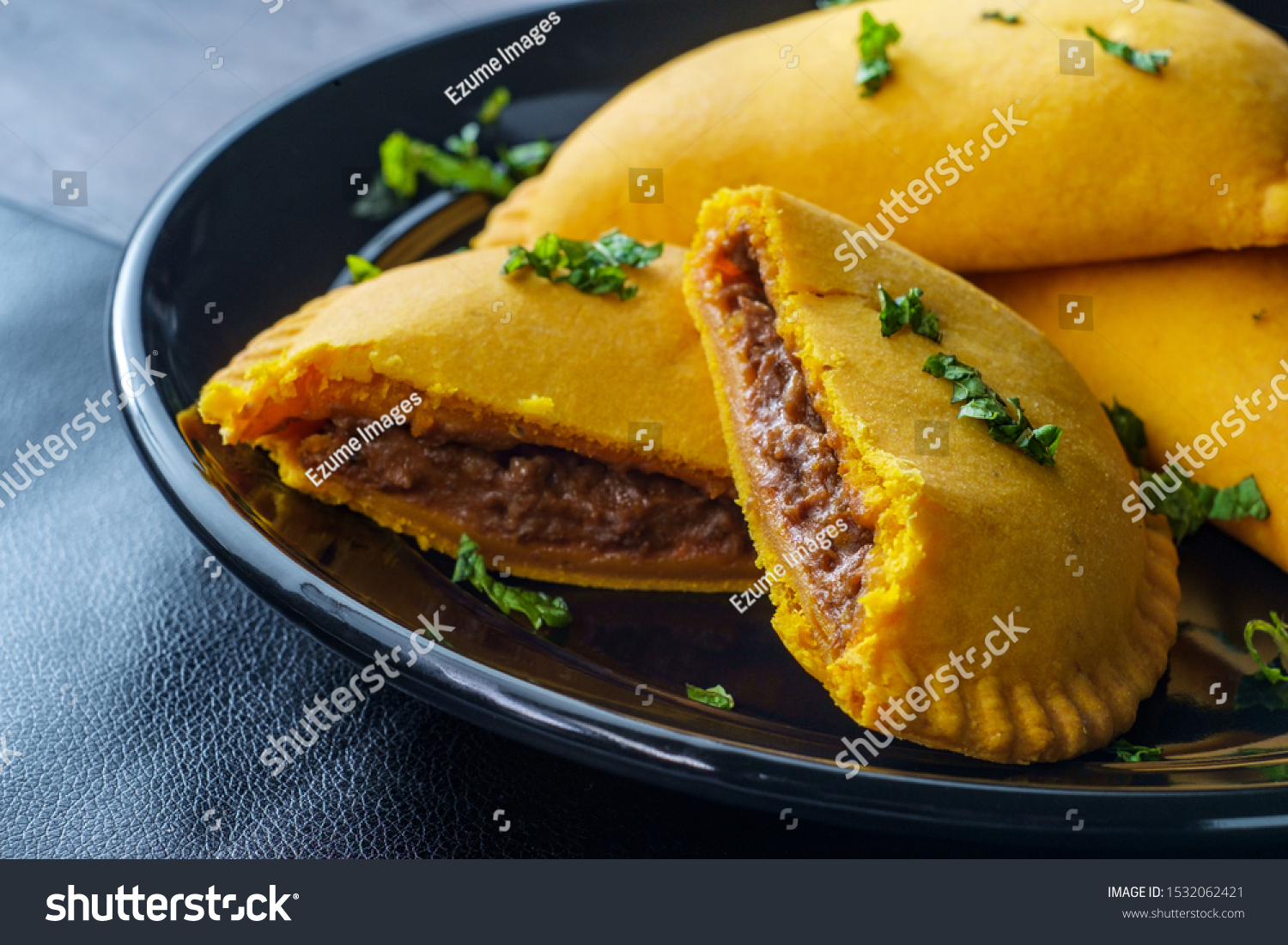 Spicy Jamaican beef turnovers with mint garnish #1532062421