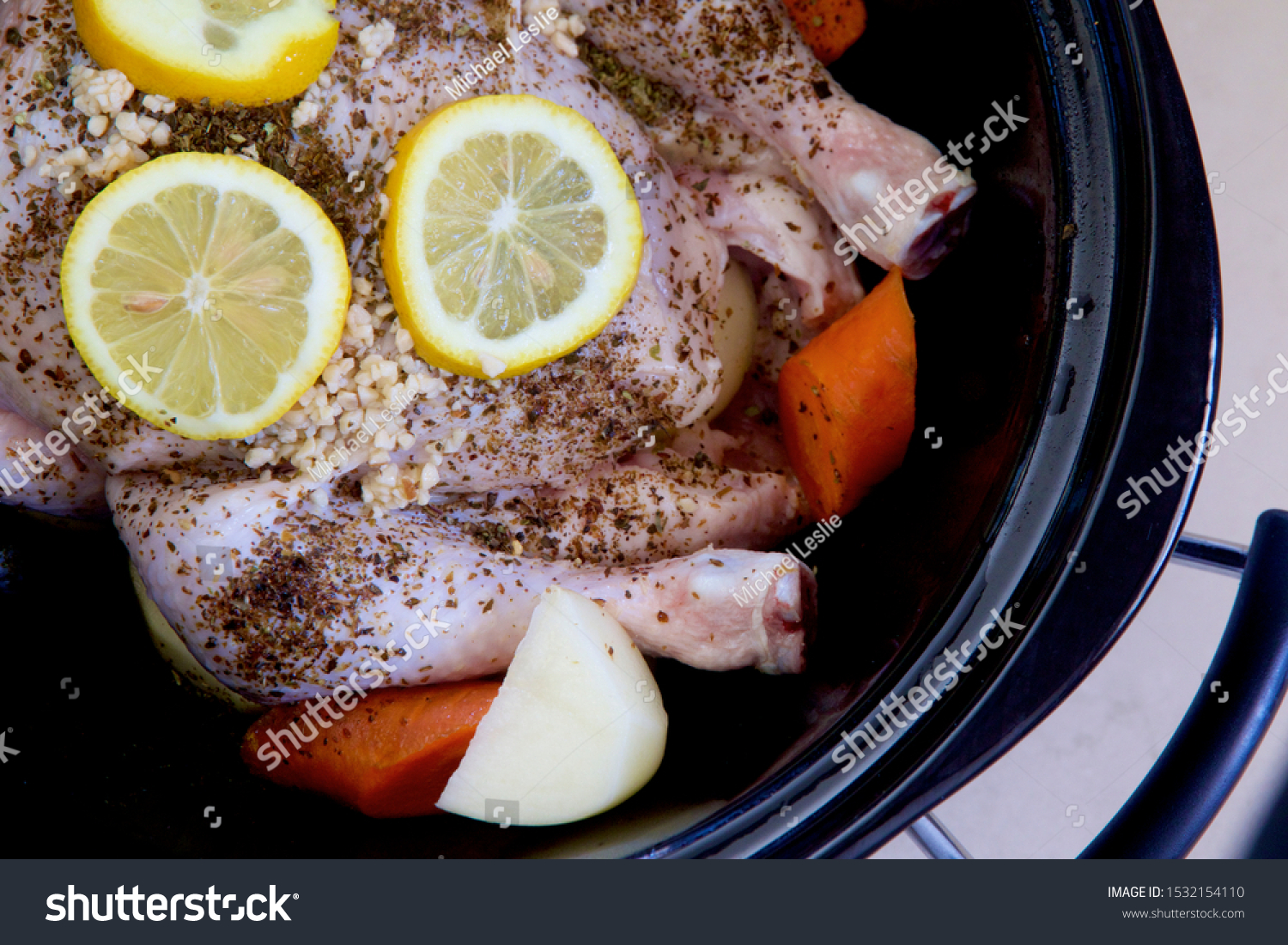 Chicken and vegetables with herbs and lemon in a slow cooker. #1532154110