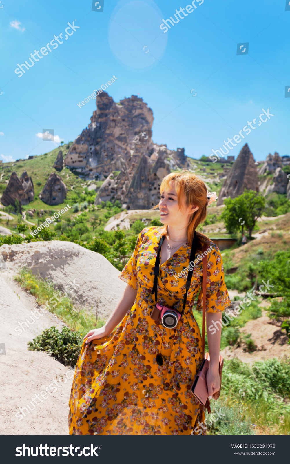 Vacation in Turkey view of Uchisar Castle Village during summer with tourist model #1532291078