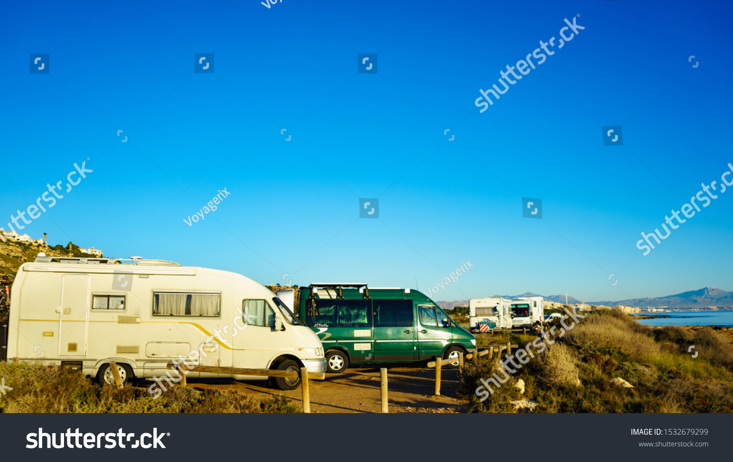 Camper, recreational vehicles on mediterranean coast in Spain. Camping on nature beach. Holidays and travel in motor home. #1532679299