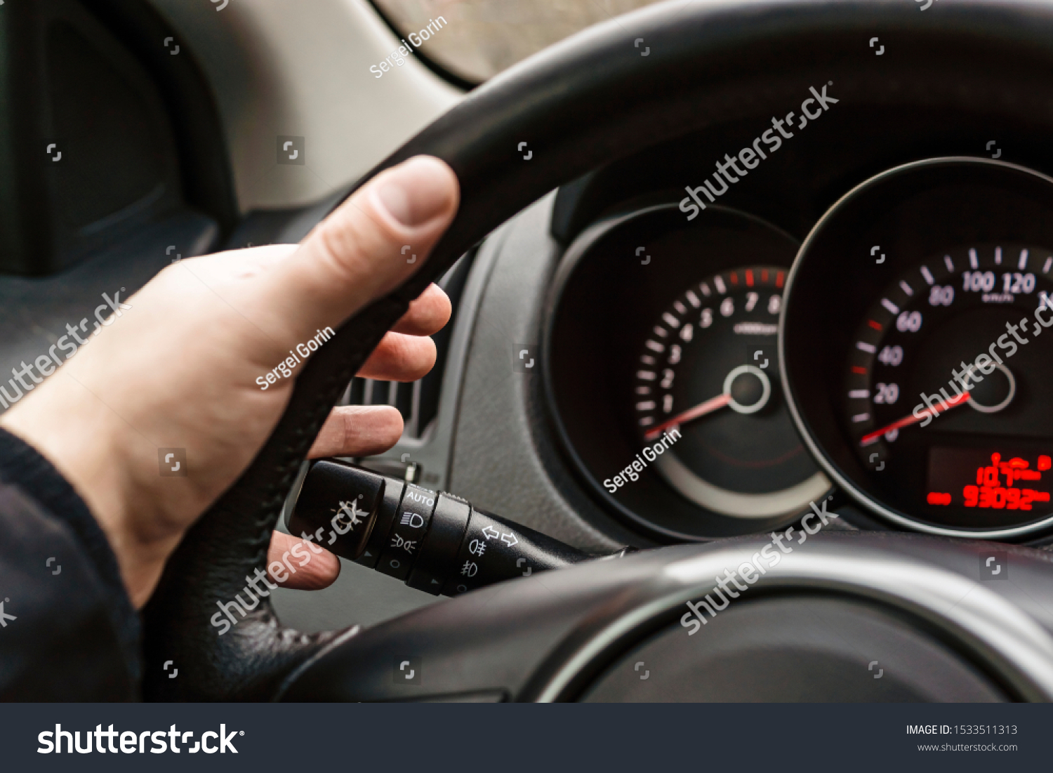 Driver's hand on steering wheel turns on turn signal #1533511313