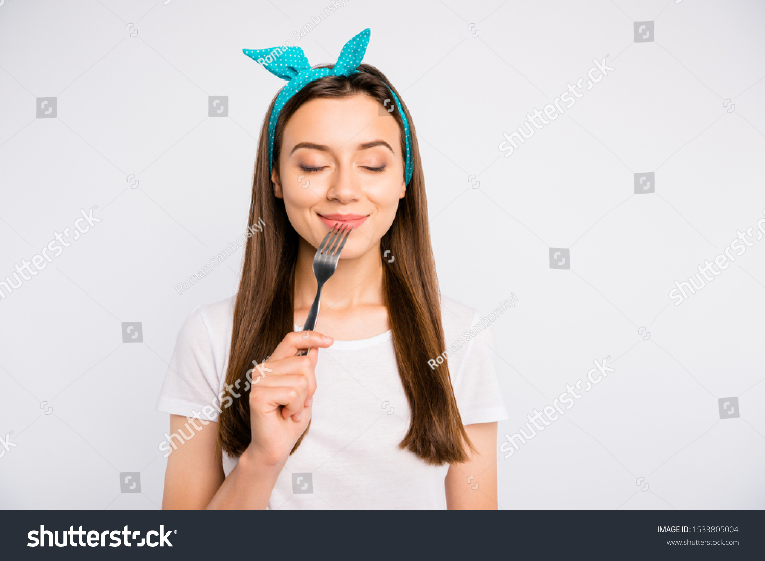 Portrait of inspired dreamy girl hold fork feel hungry want eat imagine tasty meal delicious burger close eyes wear stylish blue headband t-shirt isolated over white color background #1533805004