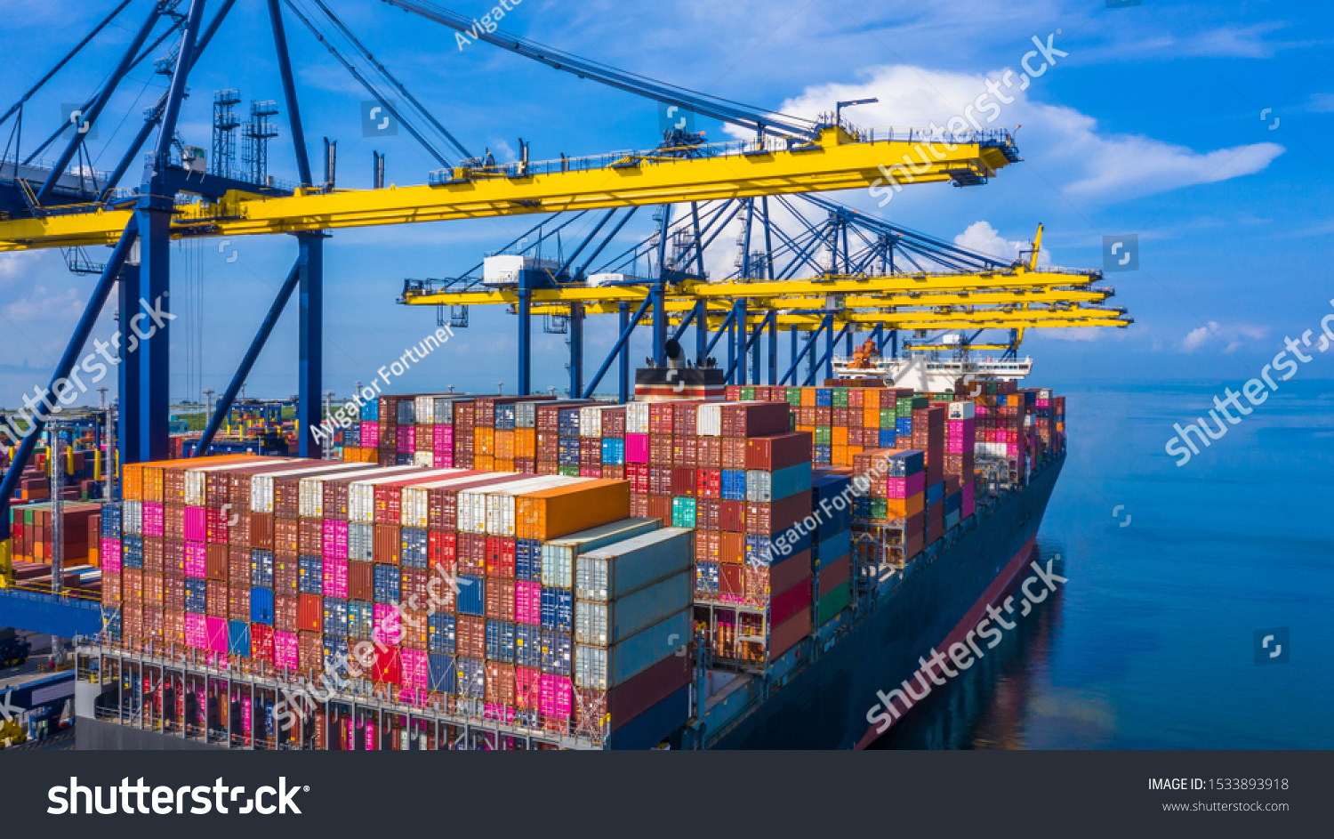 Container cargo ship at industrial port in import export commercial trade business logistic and transportation of international by container cargo ship boat in the open sea, Aerial view industry crane #1533893918