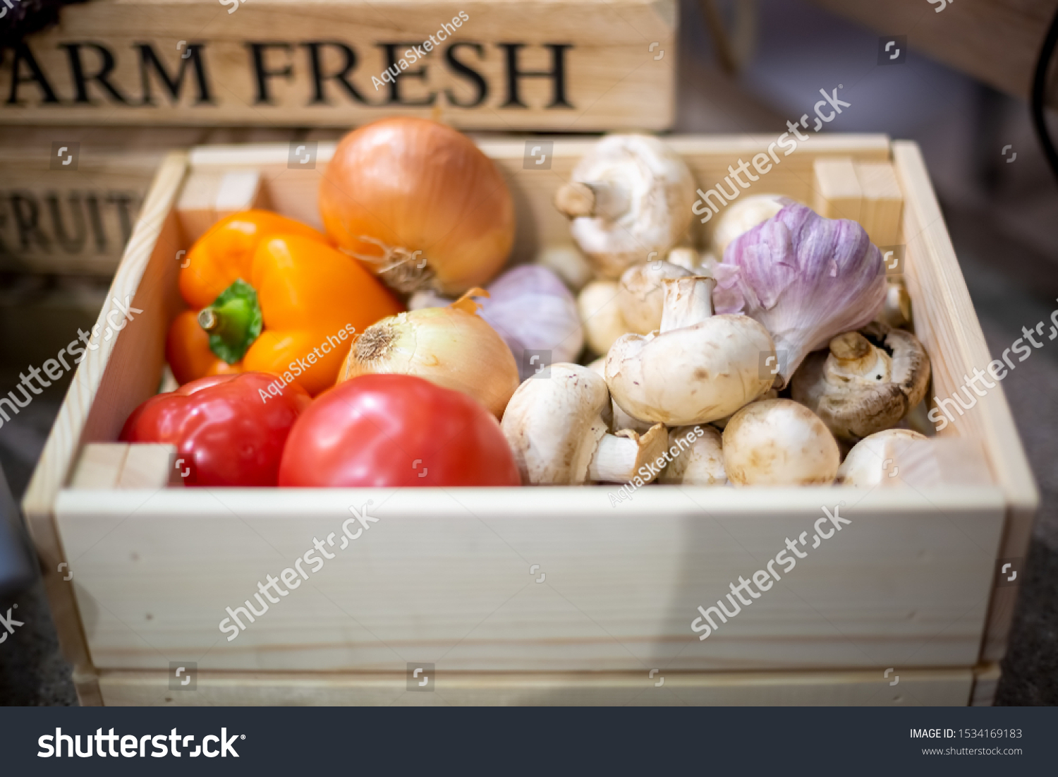 set of fresh organic vegetables garlic, champignons, onion, tomatoes and peppers lie in a light wooden box close-up. Concept of biological, bio products, bio ecology, grown by yourself, vegetarians,  #1534169183