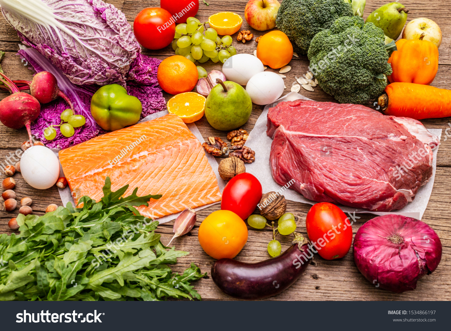 Trending paleo/pegan diet. Healthy balanced food concept. Set of fresh products, raw meat, salmon, vegetables and fruits. Old wooden boards background #1534866197