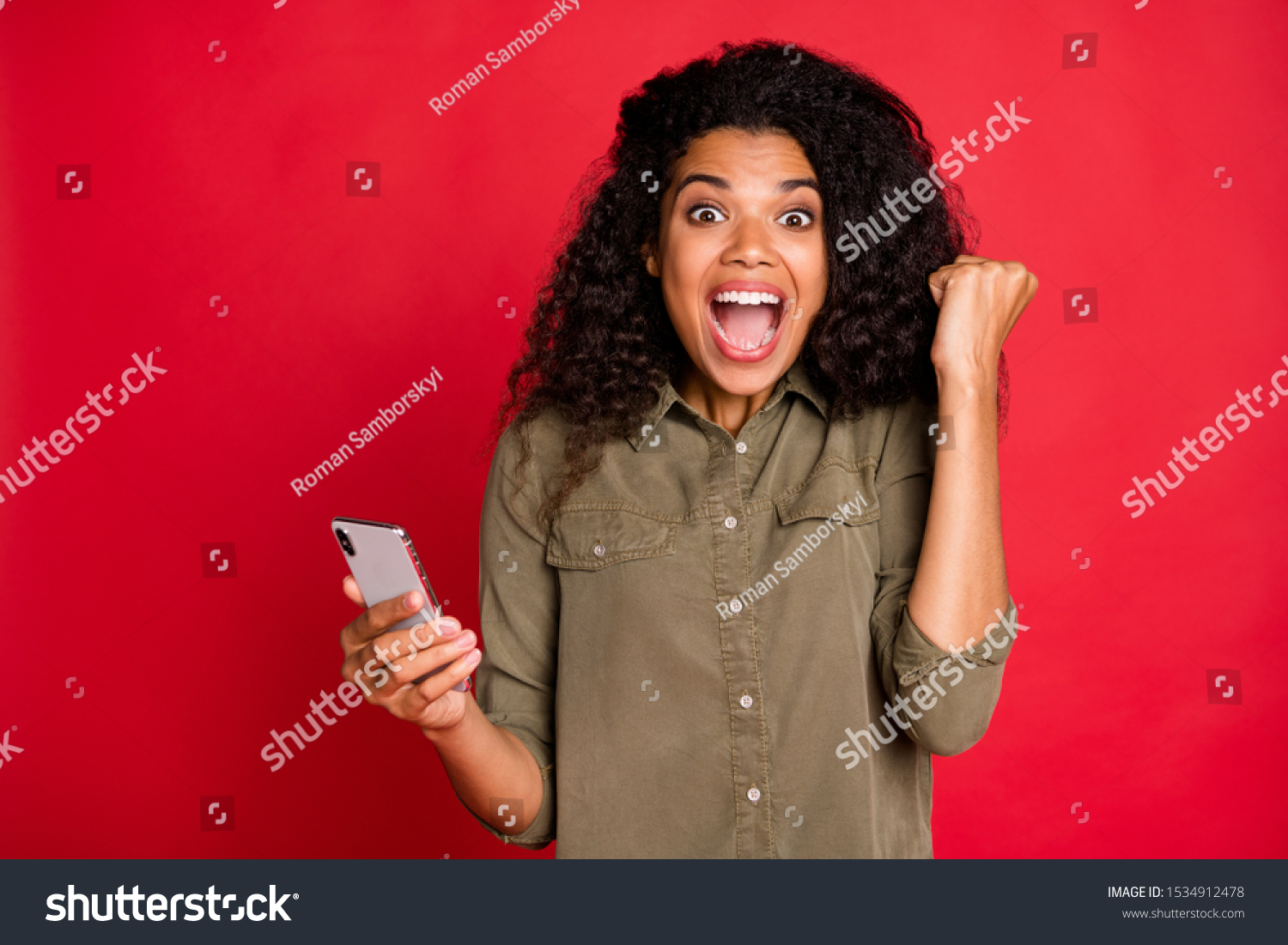 Photo of cheerful rejoicing curly wavy brunette youngster overjoyed with having won competitions shouting screaming brown haired expressing emotions feedback isolated vibrant color background #1534912478