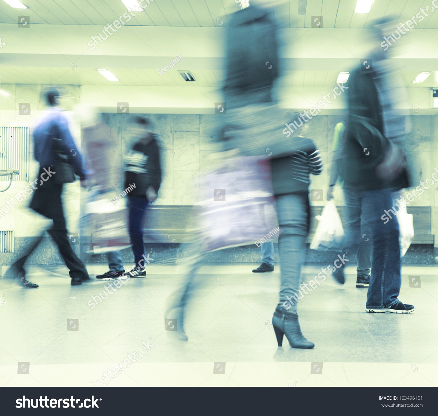 Motion blurred commuters walking in subway station. #153496151