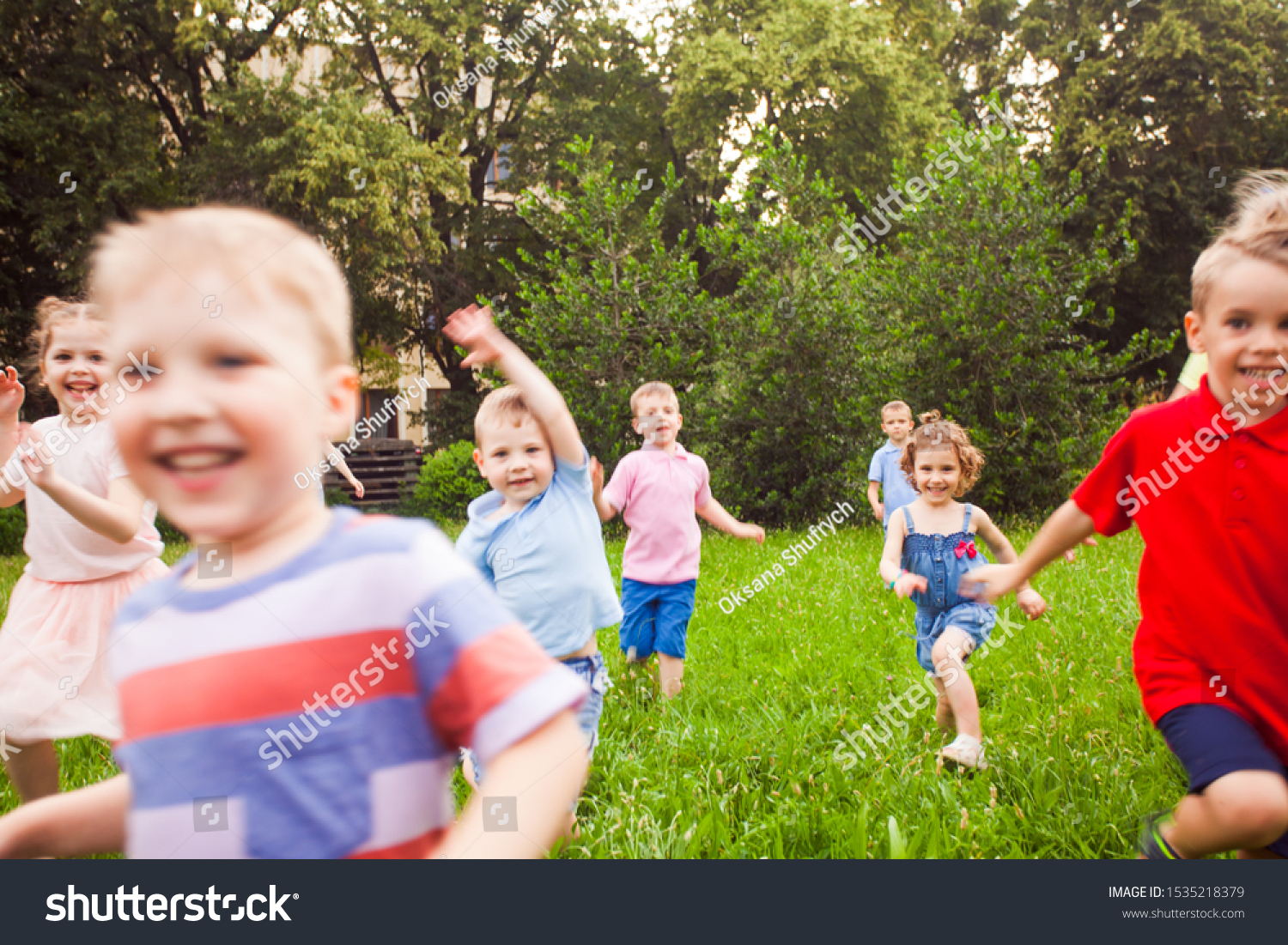 Large group of kids running in the park #1535218379