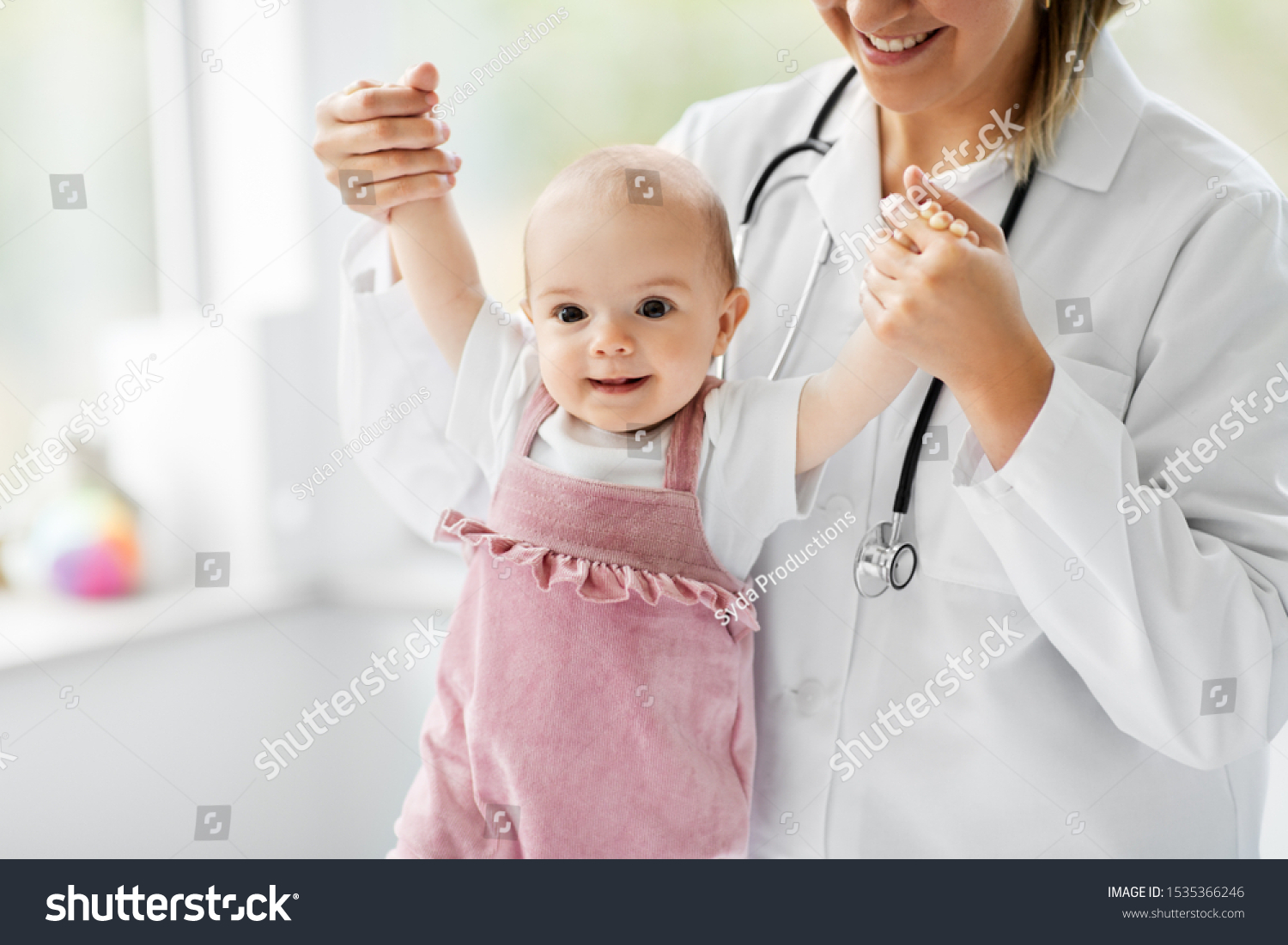 medicine, healthcare and pediatrics concept - female pediatrician or neuropathist doctor or nurse checking smiling baby girl patient's health at clinic or hospital #1535366246