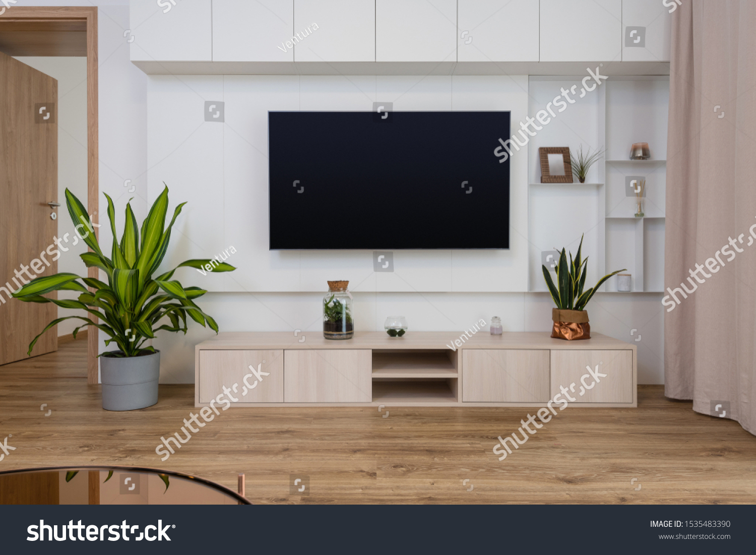 Interior of contemporary living room with TV on the wall #1535483390