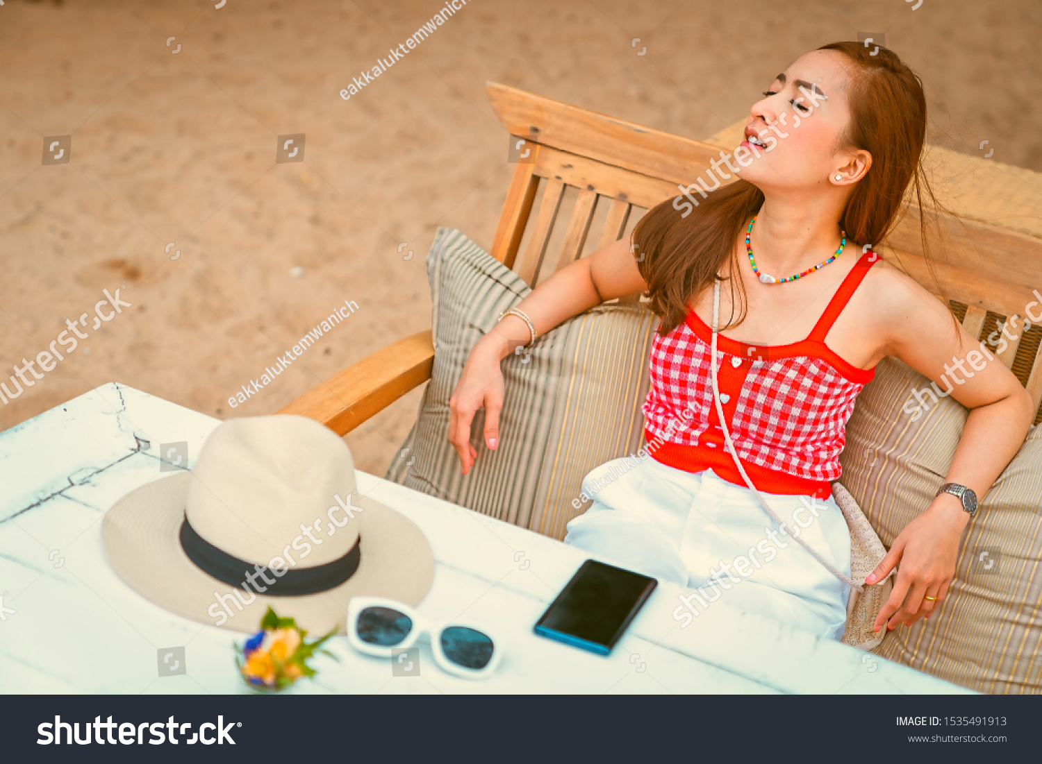 traveler girl in red dress sit on the chair in beach with vacation trip in emotional relax and smile for relax concept #1535491913