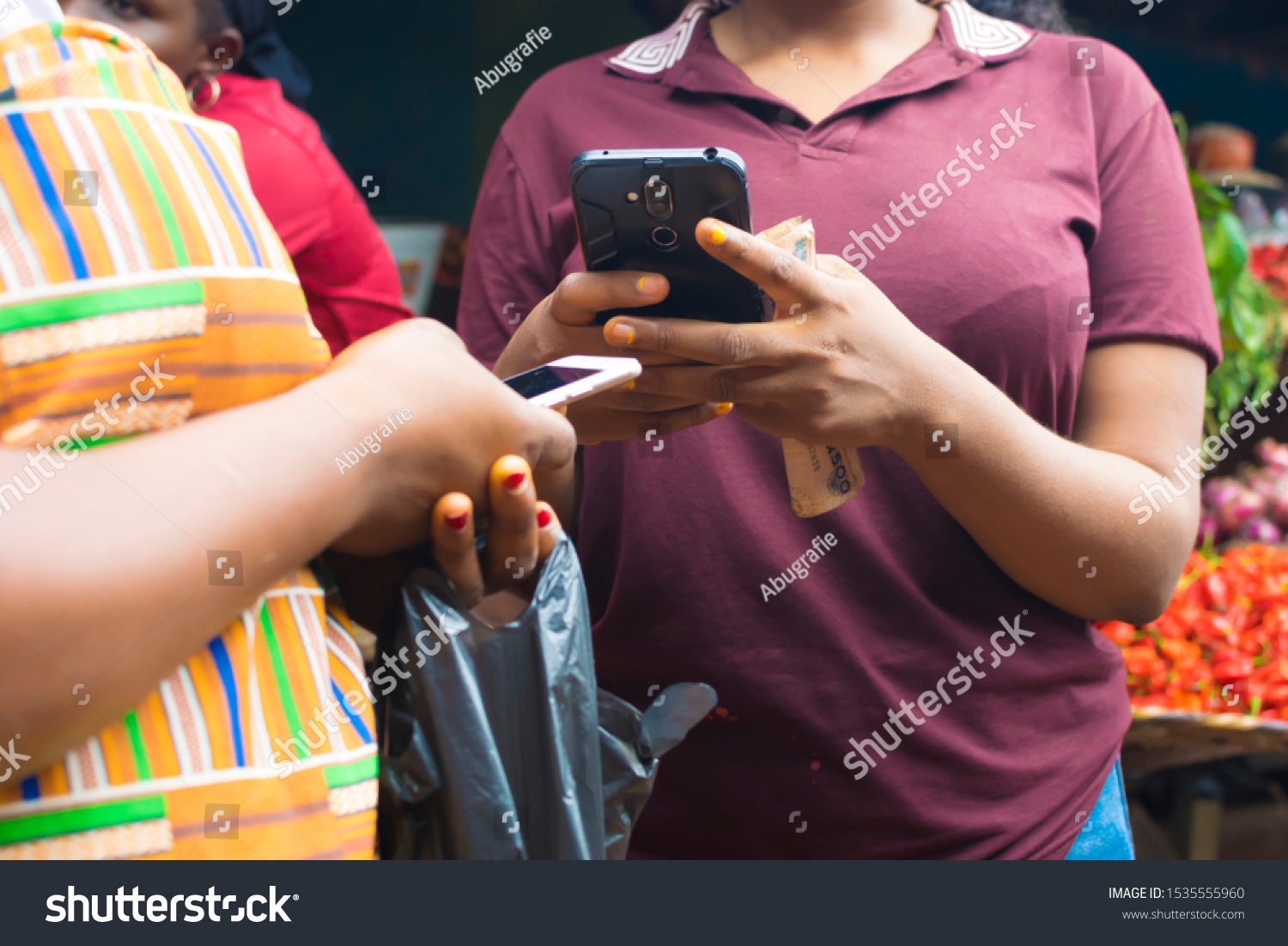Satisfied Young African hipster girl, types text message on cell phone, enjoys online communication, types feedback, Doing online Transaction, In Local Market , technology concept #1535555960