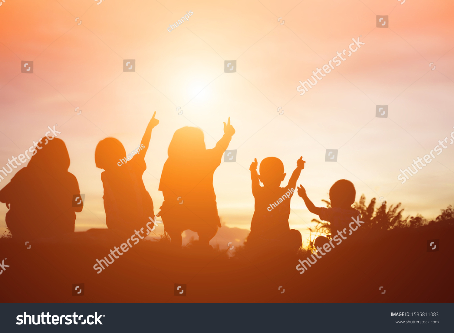 silhouette of a happy children and happy time sunset #1535811083