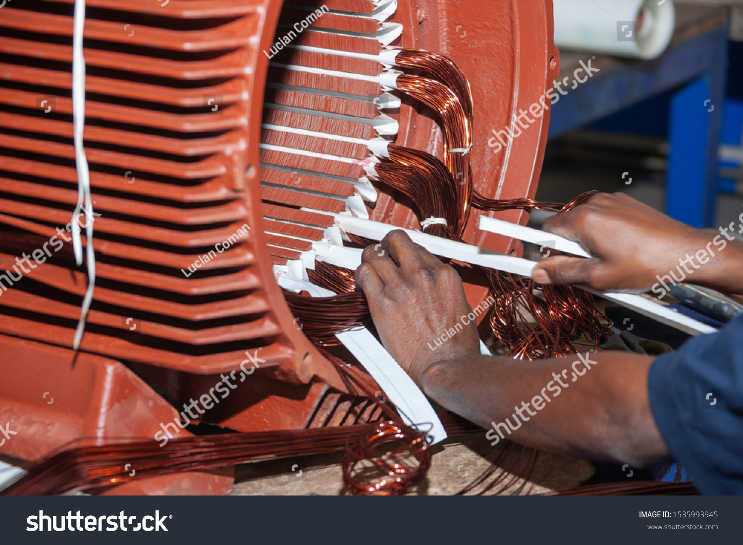 African man rewinding a giant electric motor #1535993945