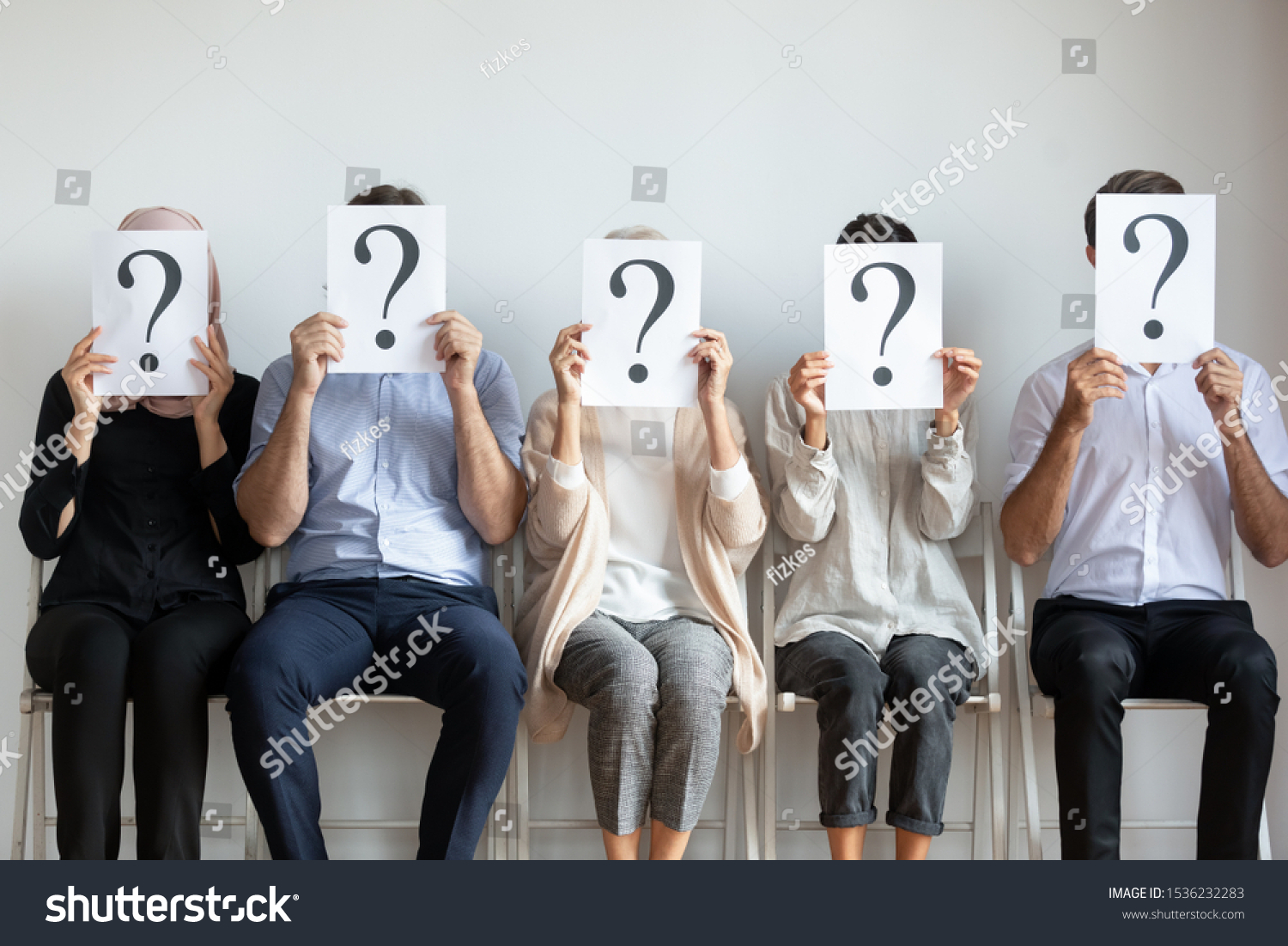 Unemployed professional business people candidates group sit on chairs in row line queue holding sheets with question mark hiding face waiting for job interview, human resources and recruit concept #1536232283