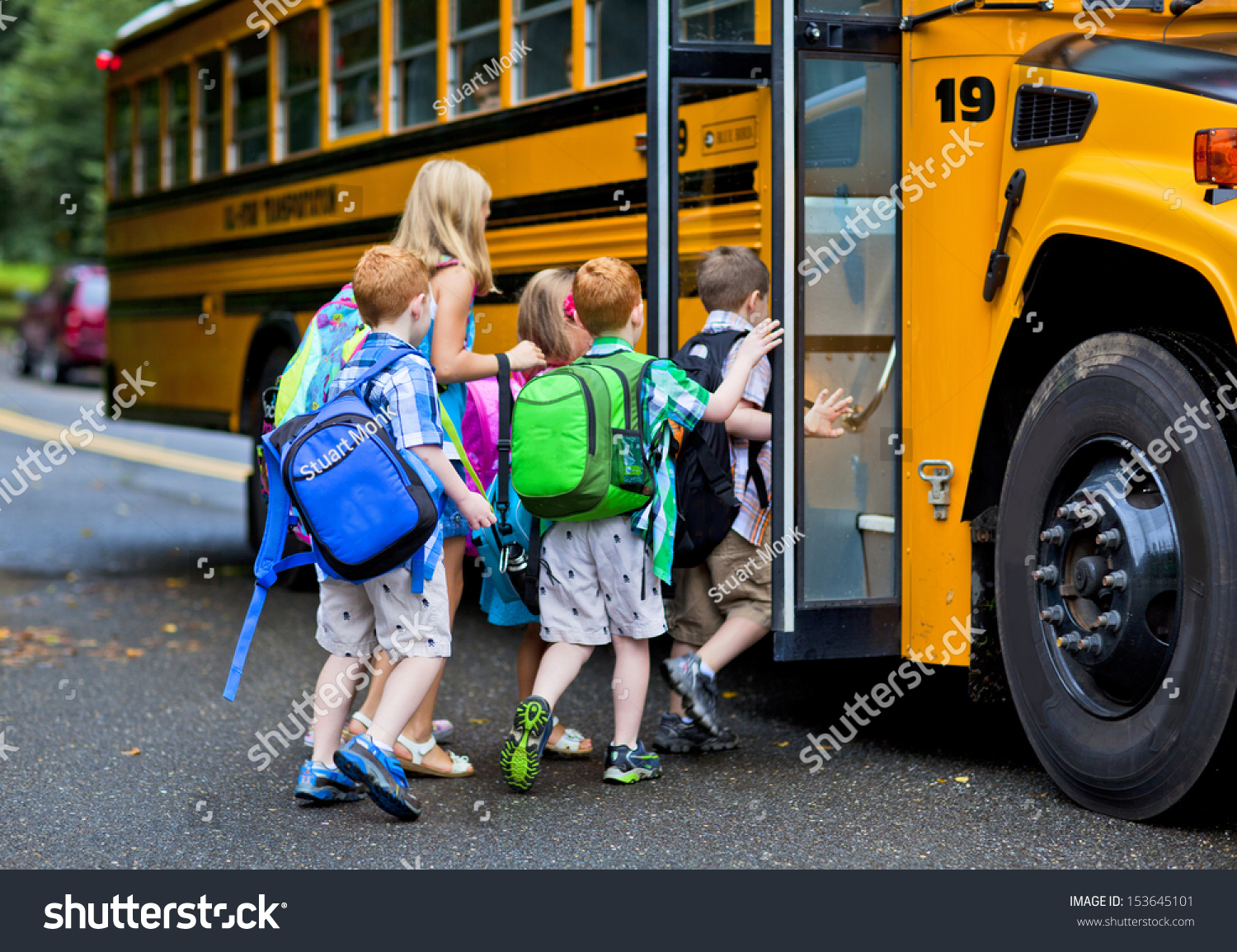 A group of young children getting on the schoolbus #153645101