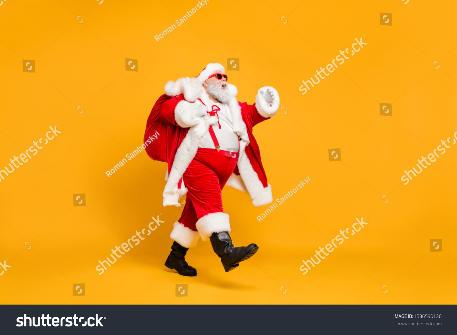 Full size profile side photo of funky fat santa claus with huge abdomen hold gift wish bag go walk travel around world on christmas night eve wear x-mas hat suspenders isolated bright color background #1536590126