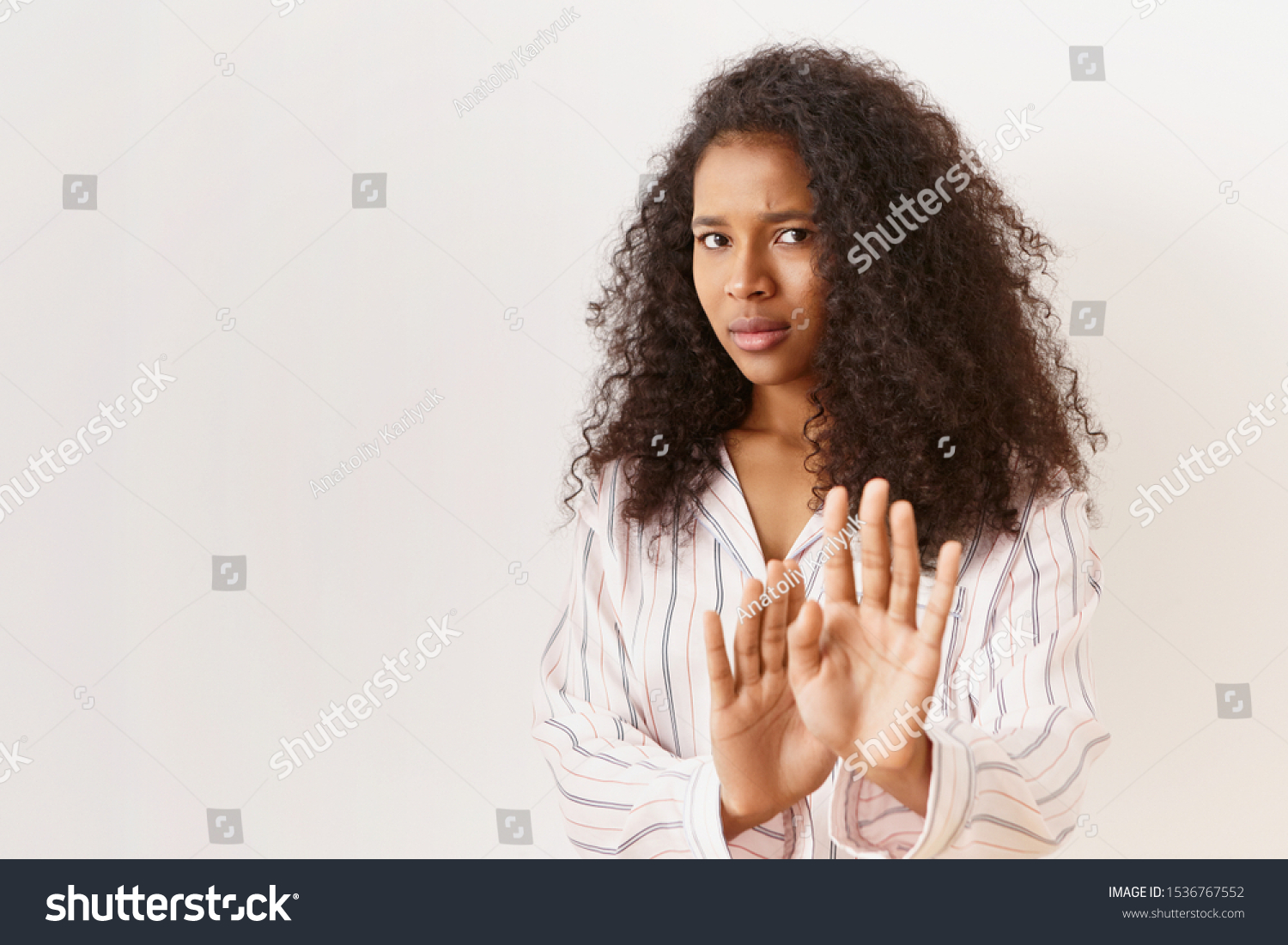 Human feelings, reaction and emotions. Isolated shot of scared young dark skinned woman having mournful terrified look, denying to do something wrong, begging you to stop, making gesture with palms #1536767552