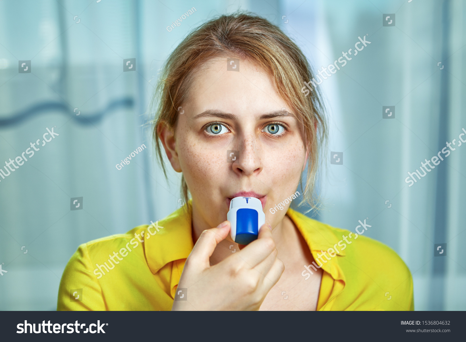 COPD or chronic obstructive pulmonary disease treatment with bronchodilator powder inhaler. A young woman uses dispenser with powders inhalation to relieve symptoms of asthma, and breathing relief.