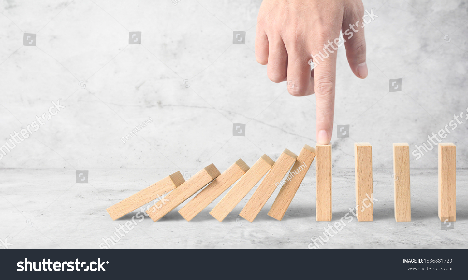 Hand stopping the Domino effect stopped by unique, Business Ideas #1536881720