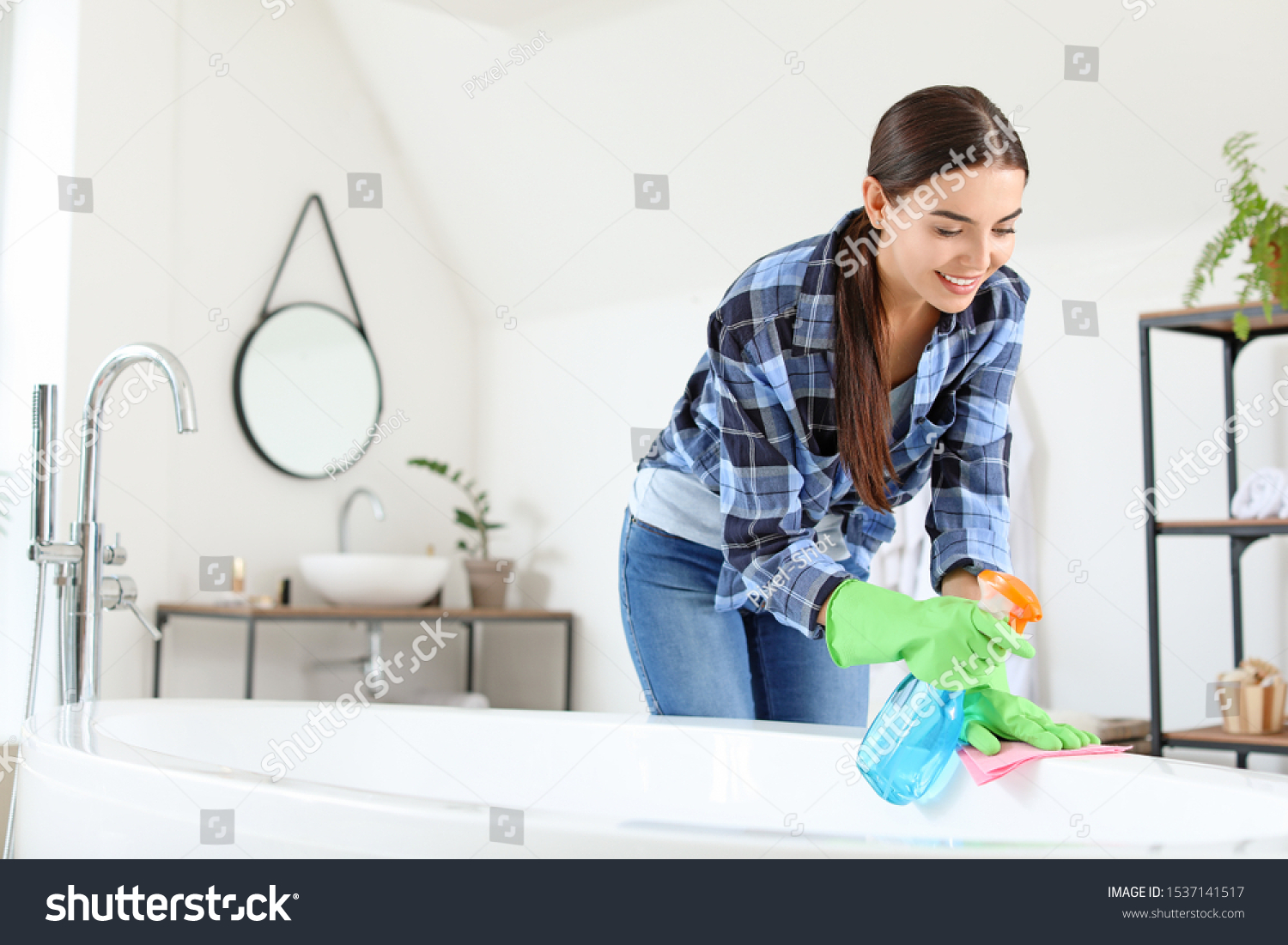 Beautiful young woman cleaning bathroom #1537141517