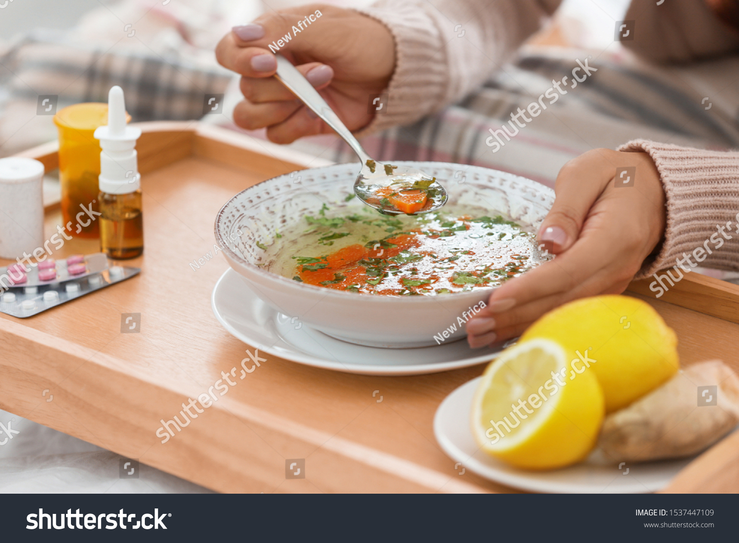 Sick young woman eating soup to cure flu, closeup #1537447109
