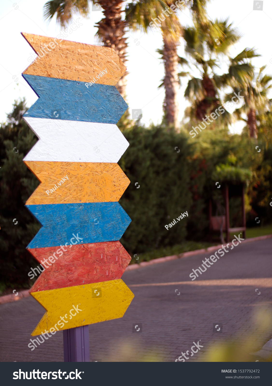 Colorful pointers on the background of the park. Signpost directional arrows. Direction sign, empty frame for designers #1537792472