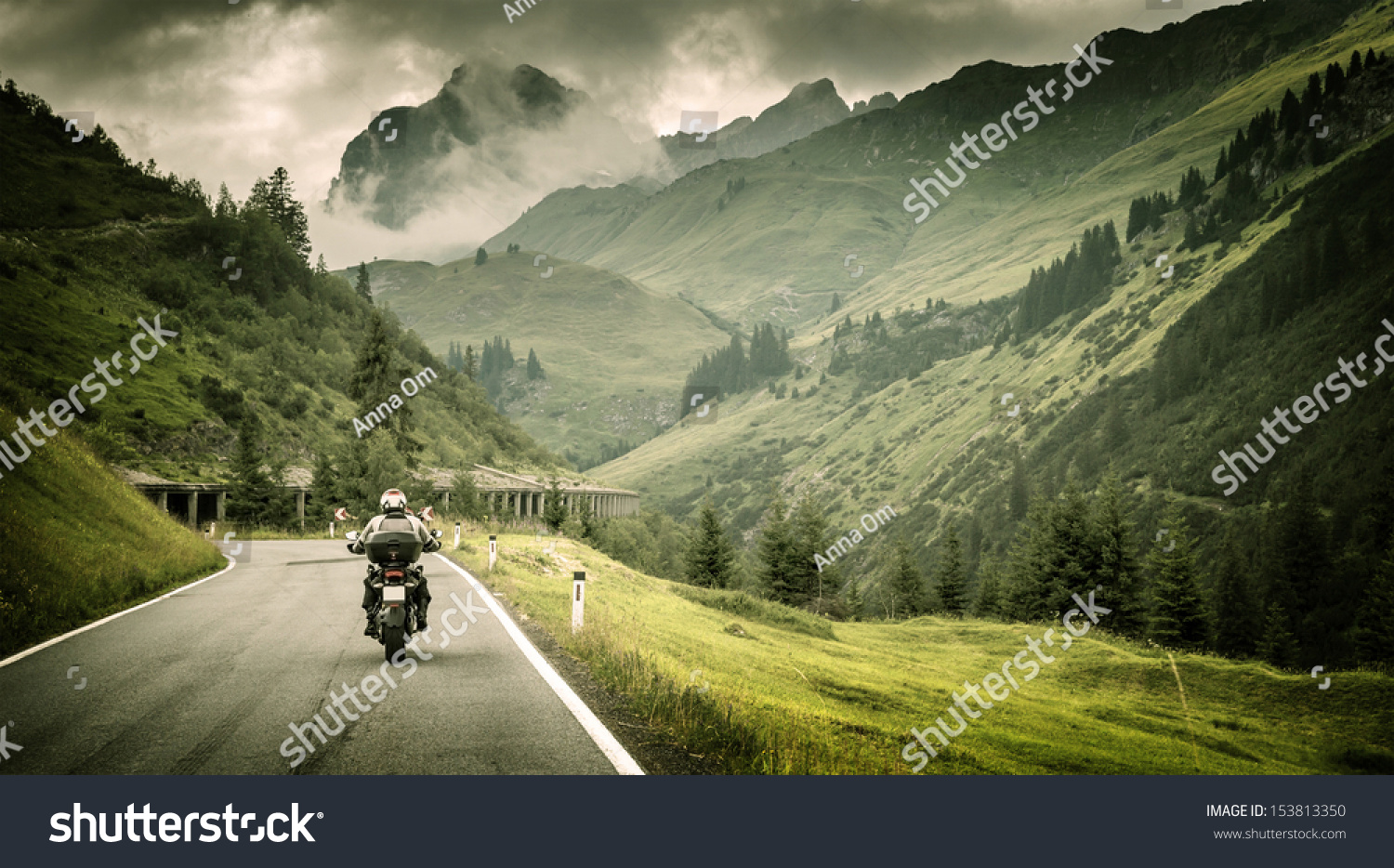 Motorcyclist on mountainous highway, cold overcast weather, Europe, Austria, Alps, extreme sport, active lifestyle, adventure touring concept #153813350