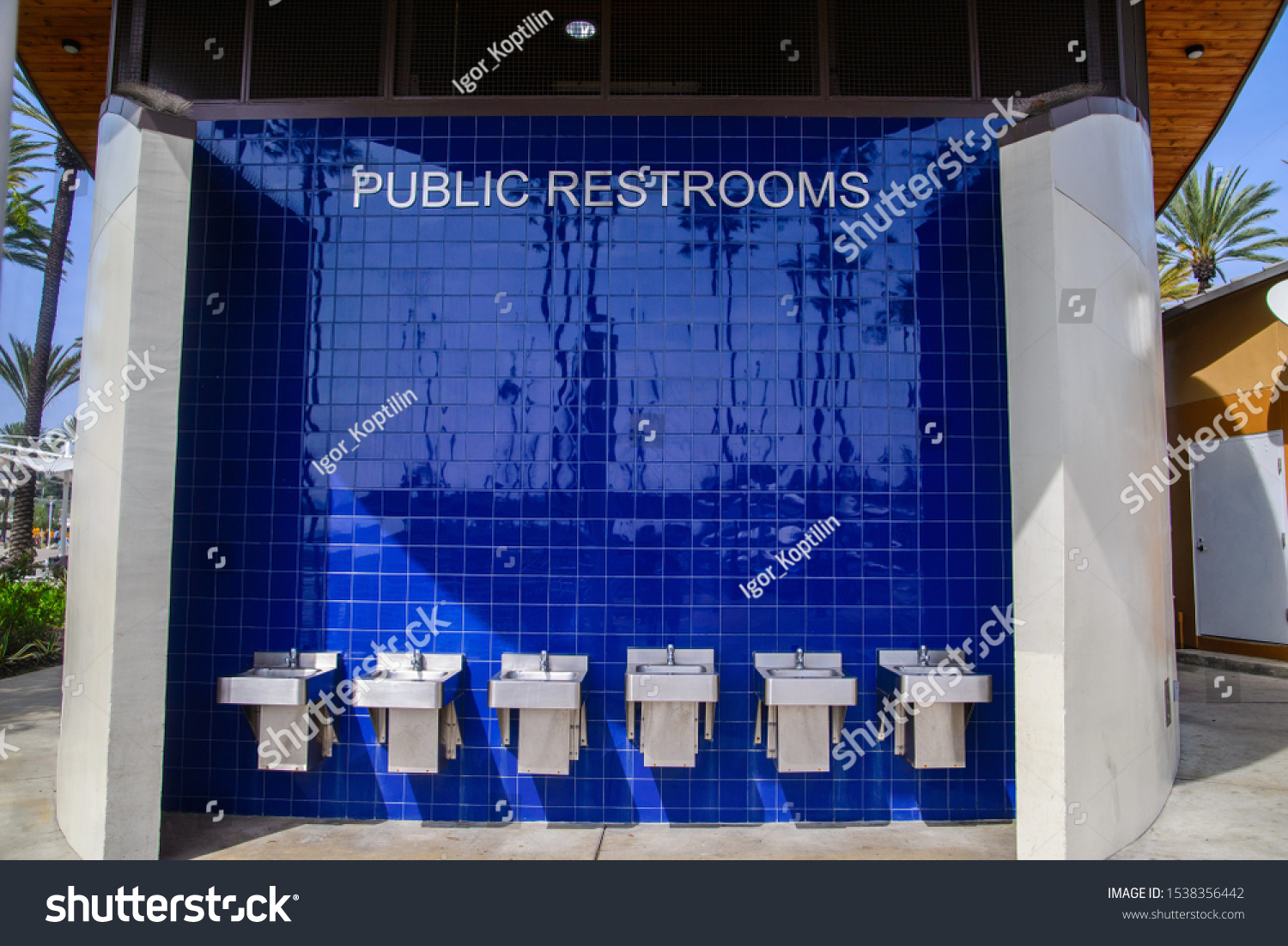 simple design of a public restrooms. washroom on open air by the restroom. blue tiles wall #1538356442